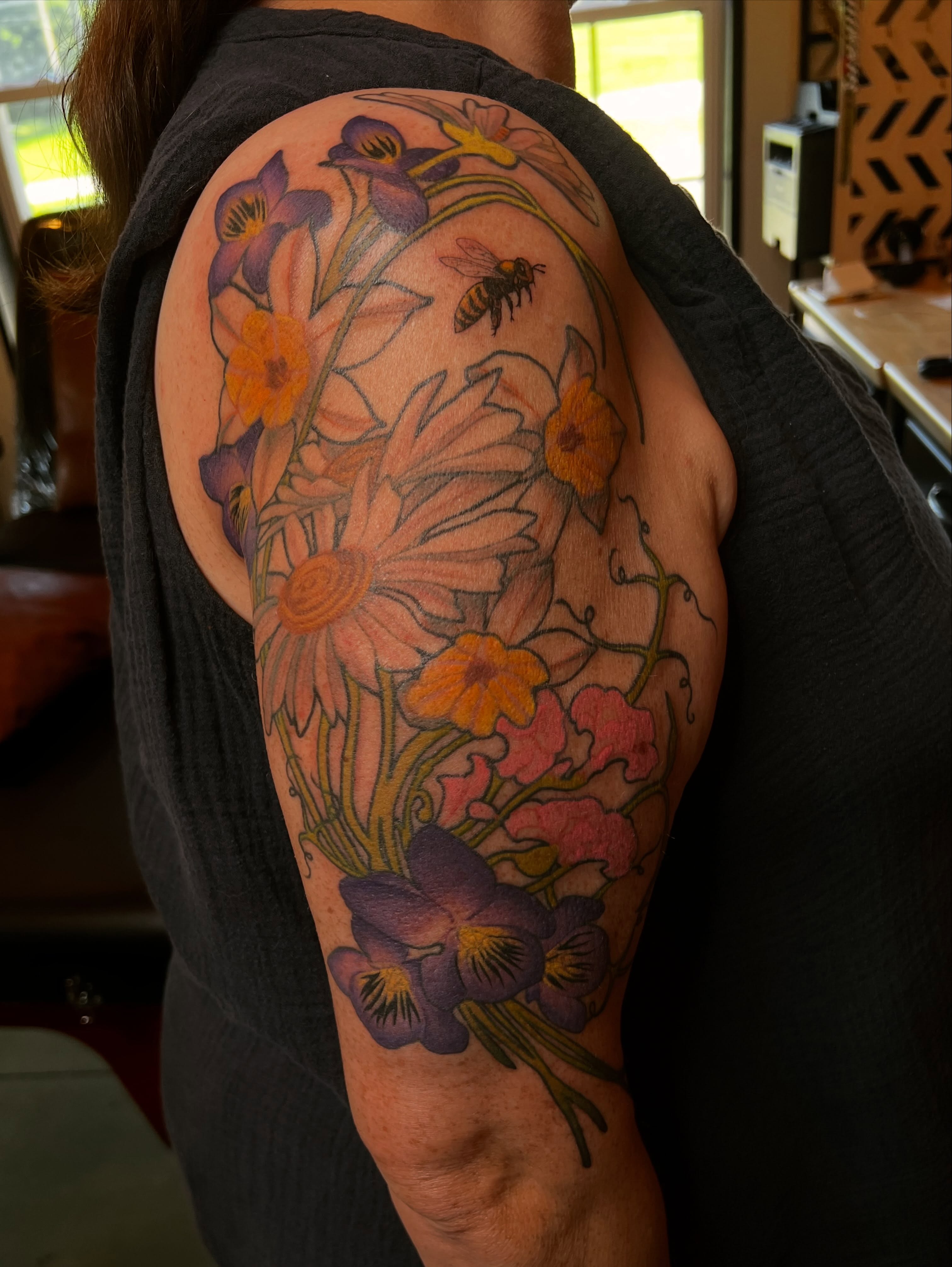 Floral bouquet new school tattoo on the upper arm by Amanda Leitch