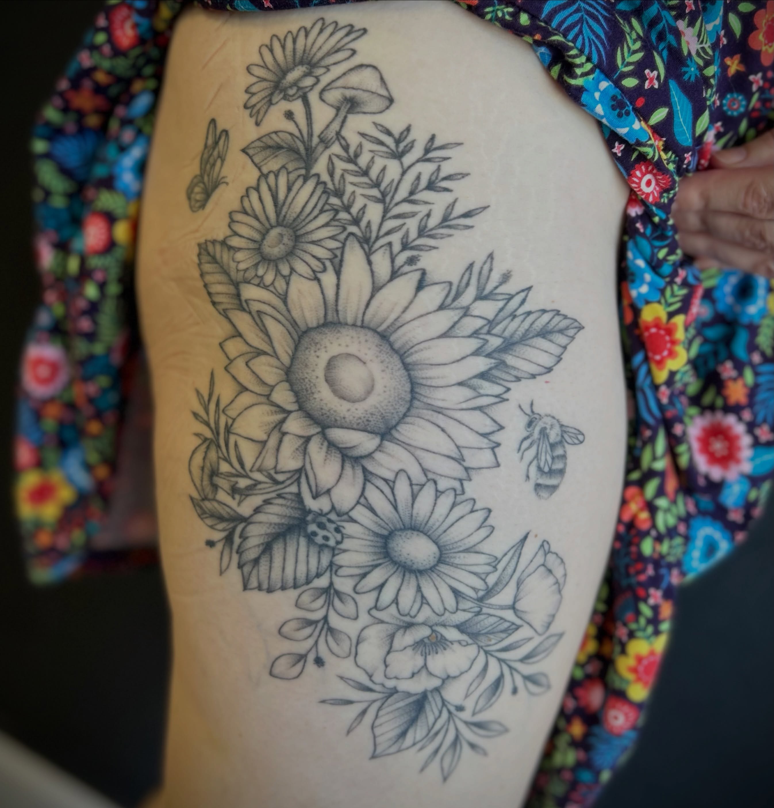 Sunflower bouquet realism tattoo on the thigh by Browtique & Ink, Clearwater, Florida