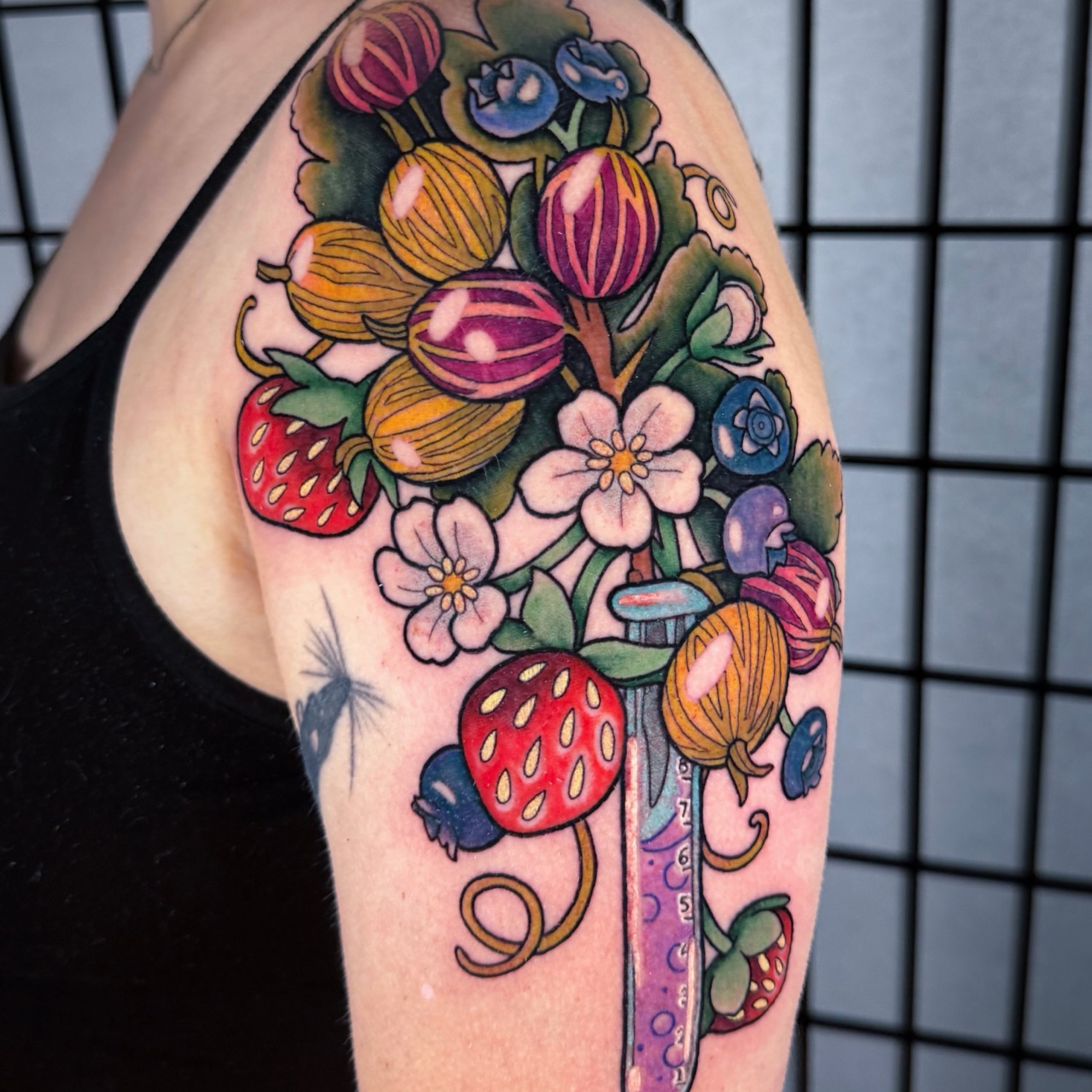 Fruit bouquet new school tattoo on the upper arm by rocky love