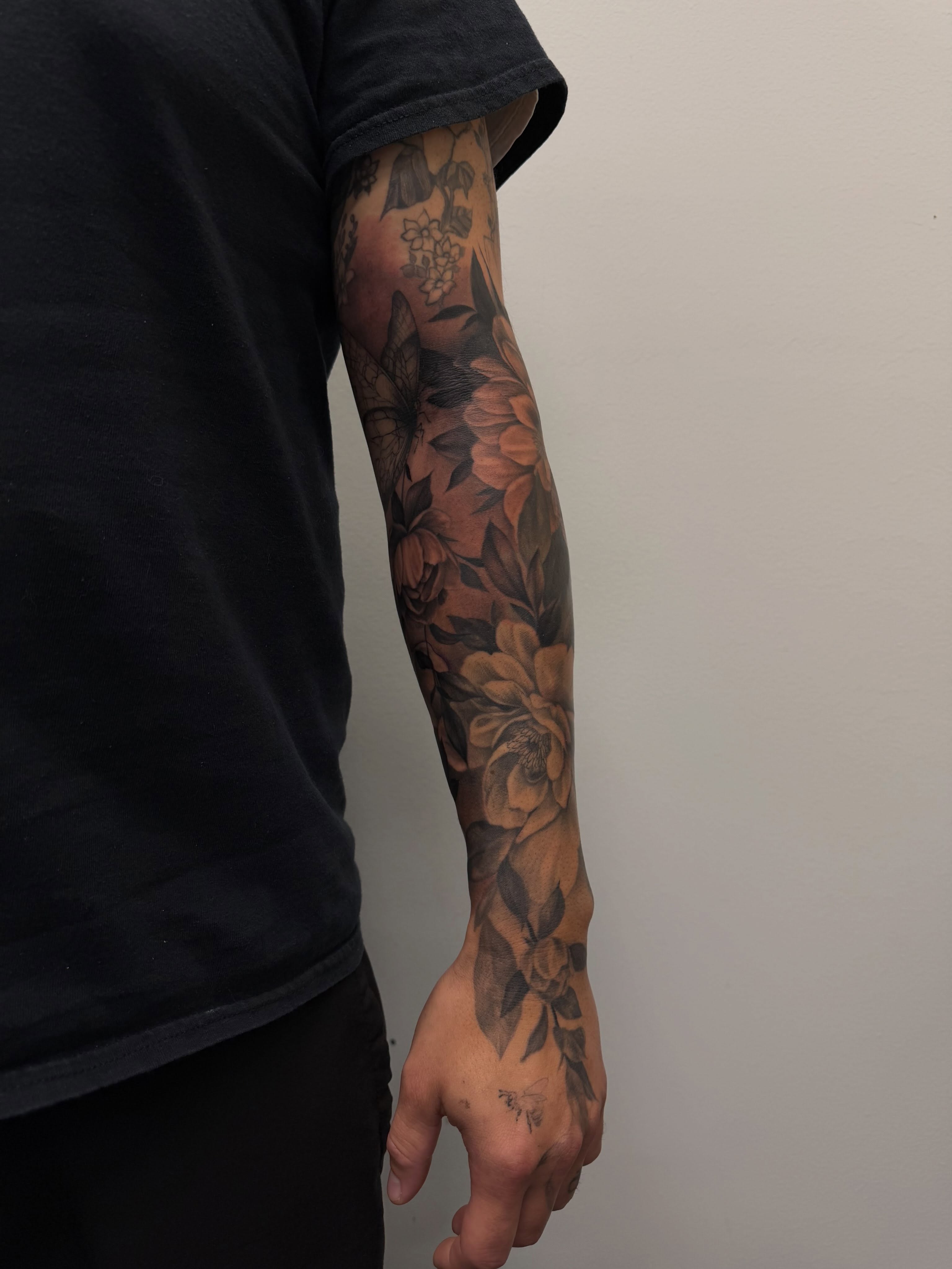 Floral bouquet black and grey tattoo on the forearm by Sam Oakes