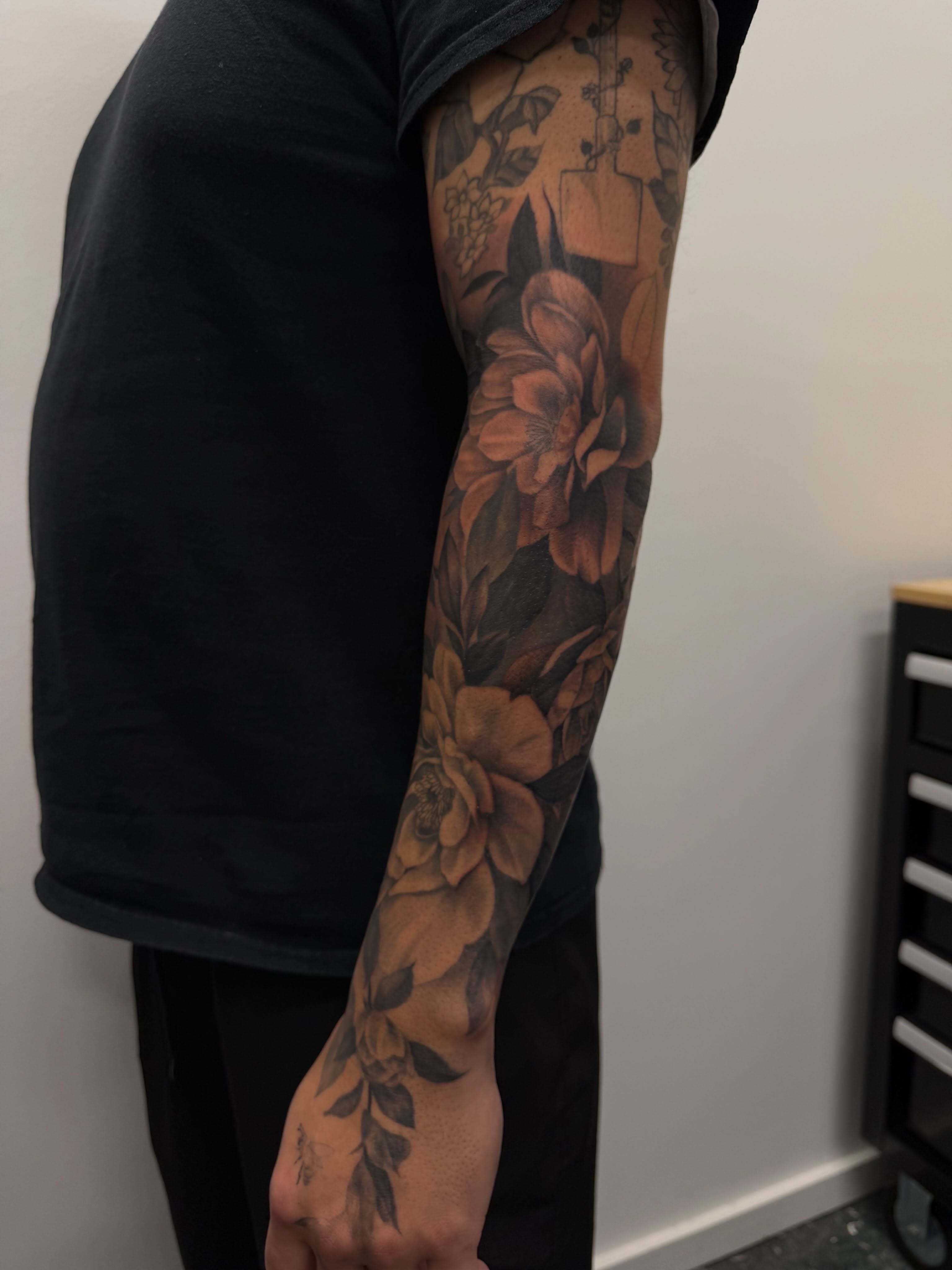 Floral bouquet realism tattoo on the forearm by Sam Oakes