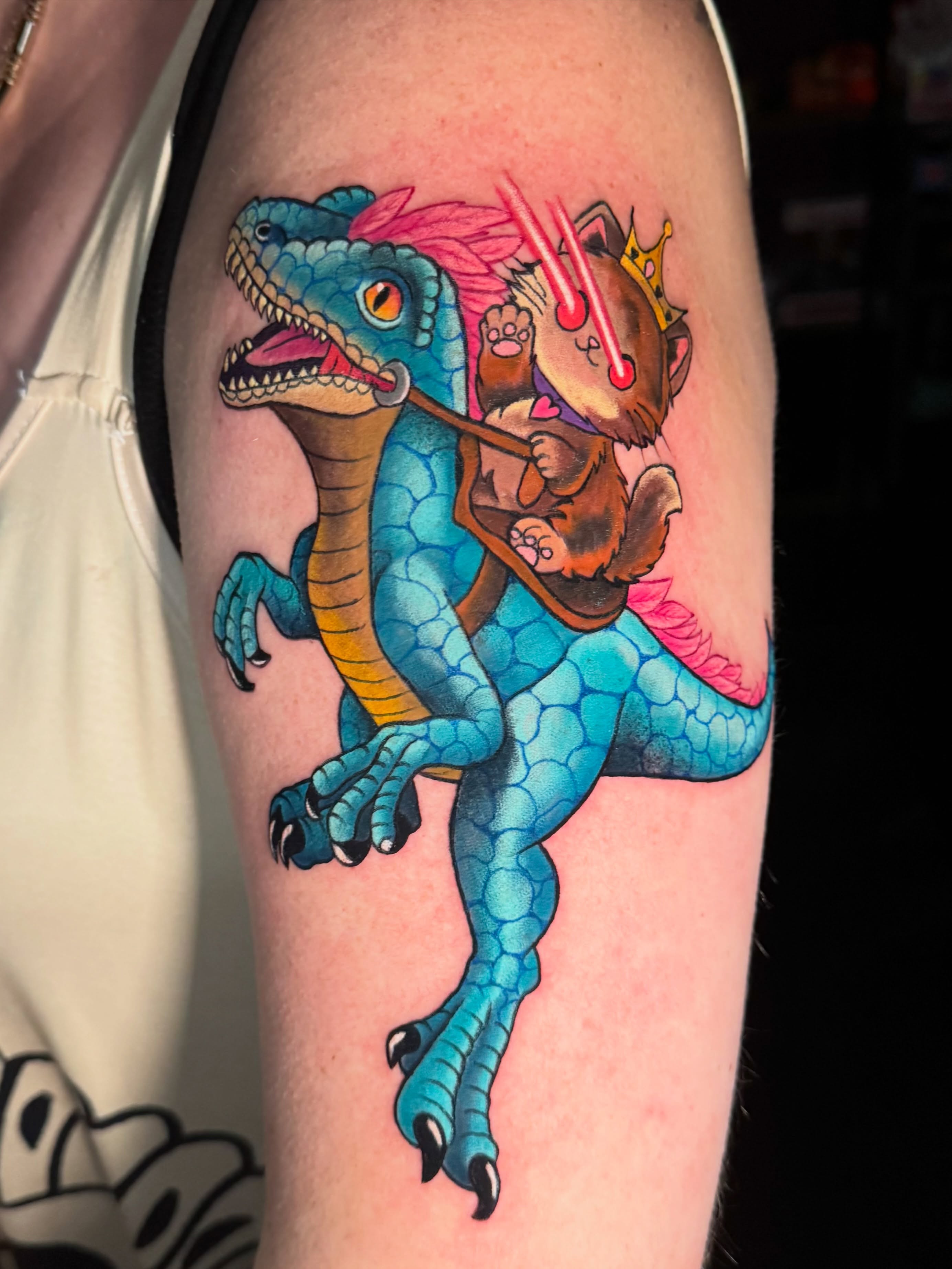 Dinosaur and cat illustrative tattoo on the forearm by Jennifer Kovach, Gastonia, North Carolina