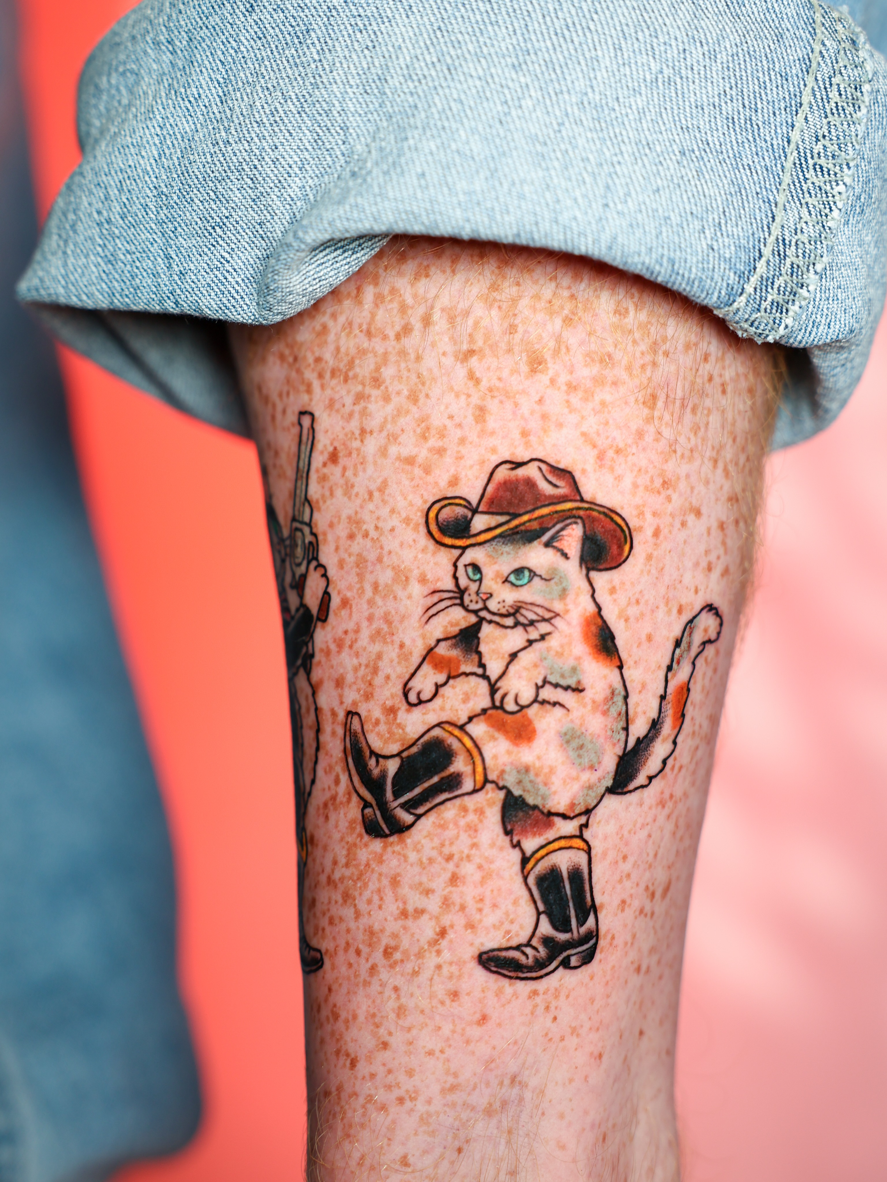 Cowboy cat American traditional tattoo on the thigh by Josh Brownell