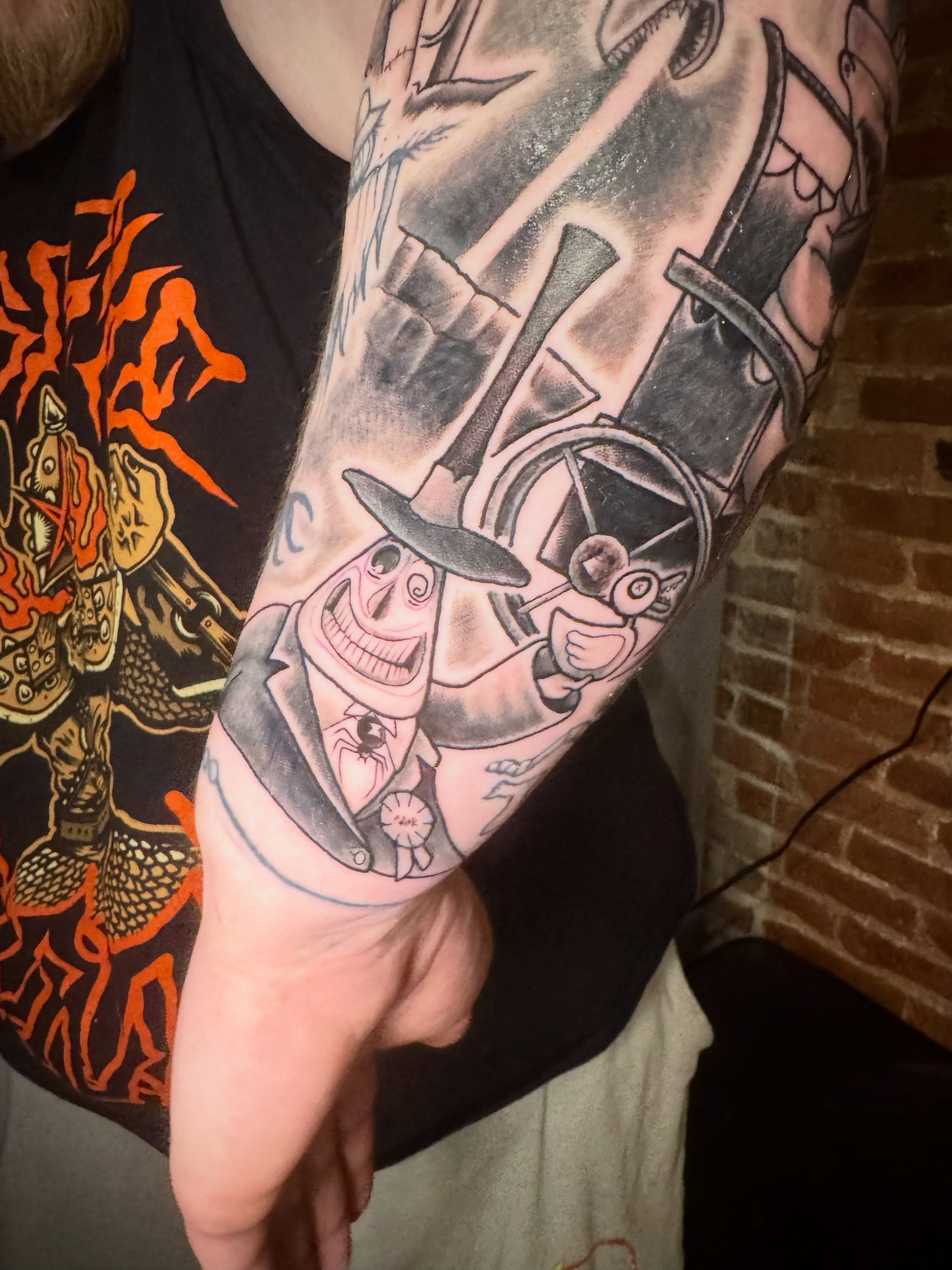 Joker character American traditional tattoo on the forearm by Nathanial Gagnon