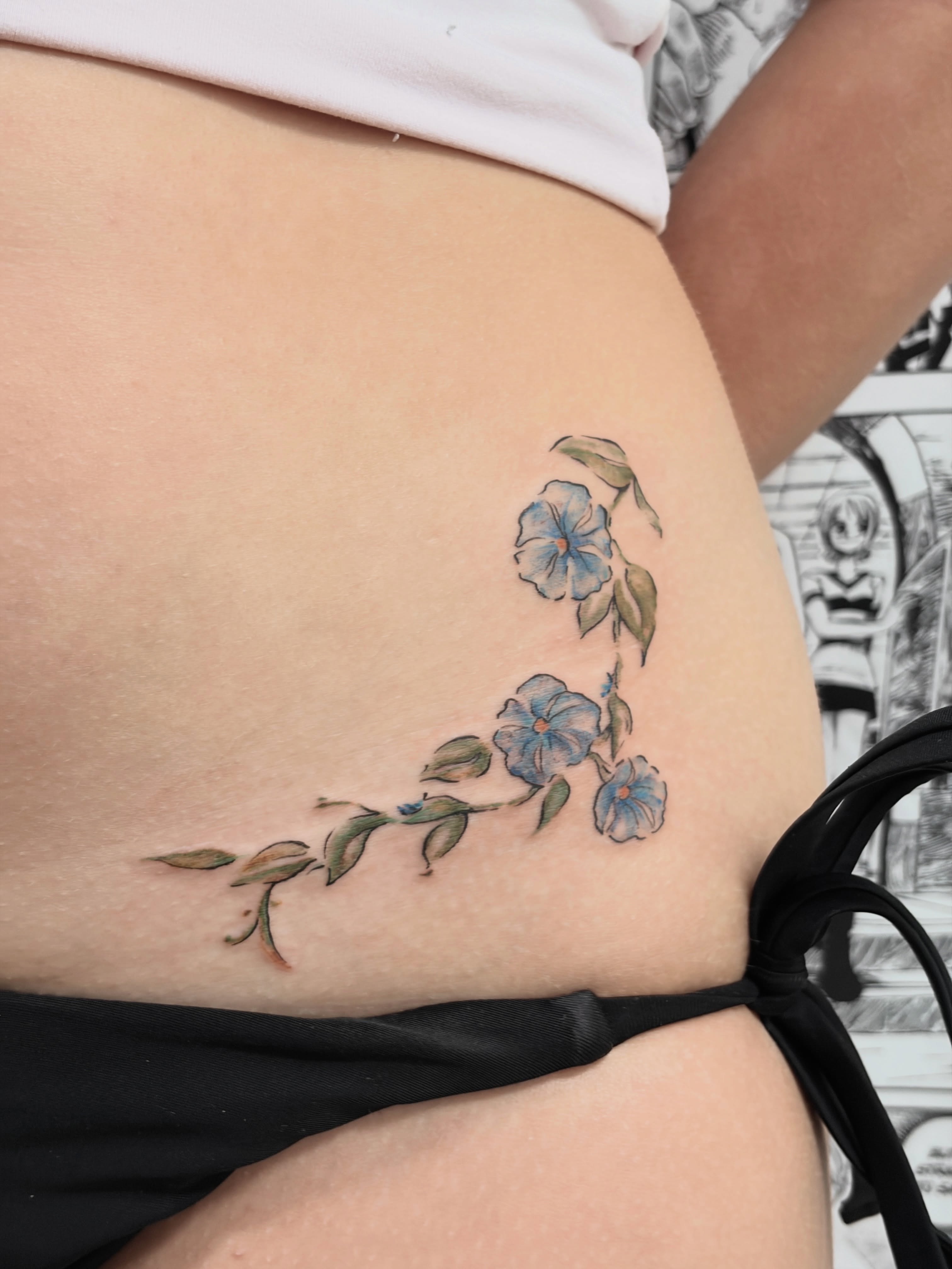 Blue flowers watercolor tattoo on the thigh by Chris, Cleveland, Ohio