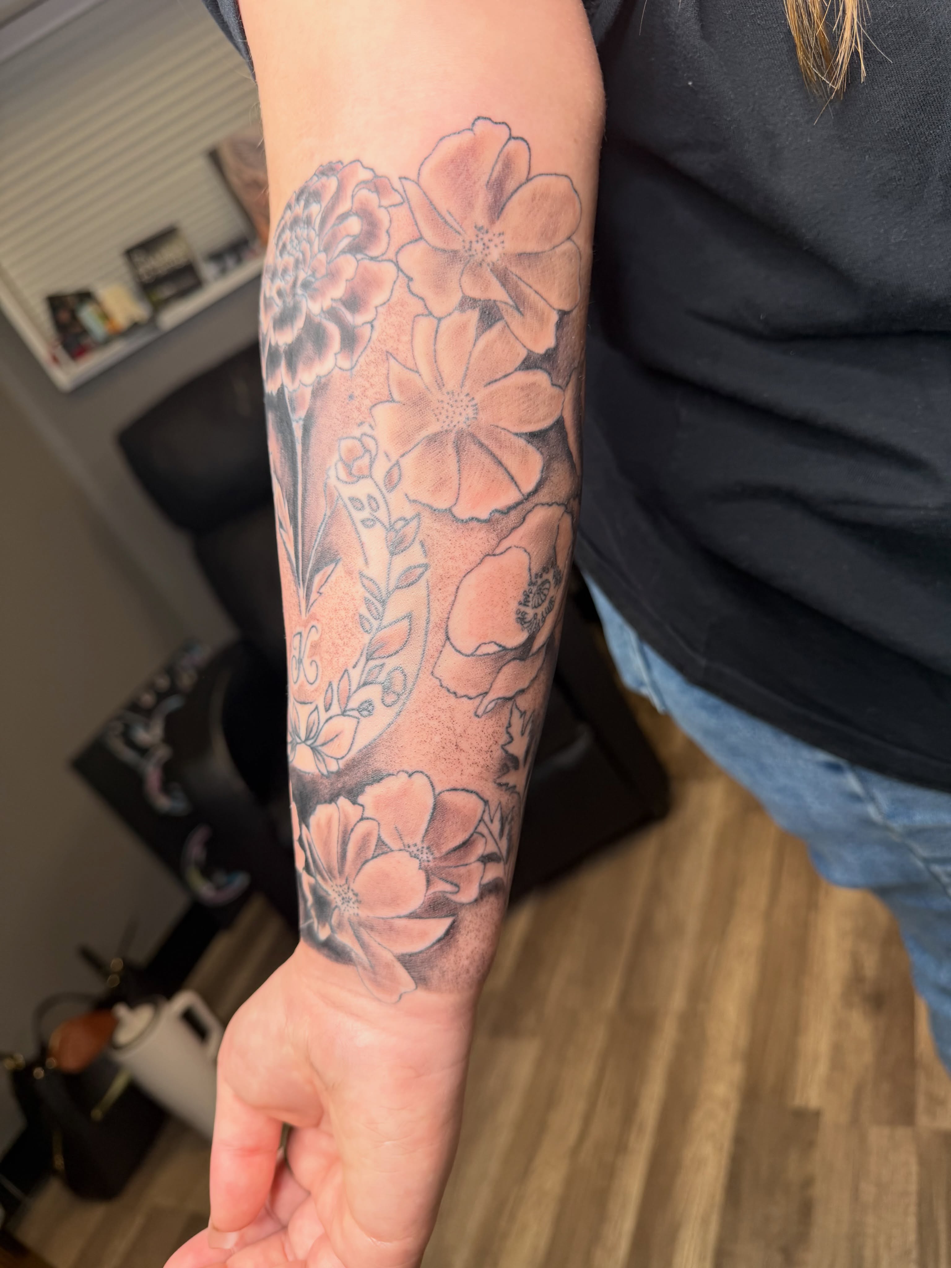 Floral bouquet black and grey tattoo on the forearm by Rain David