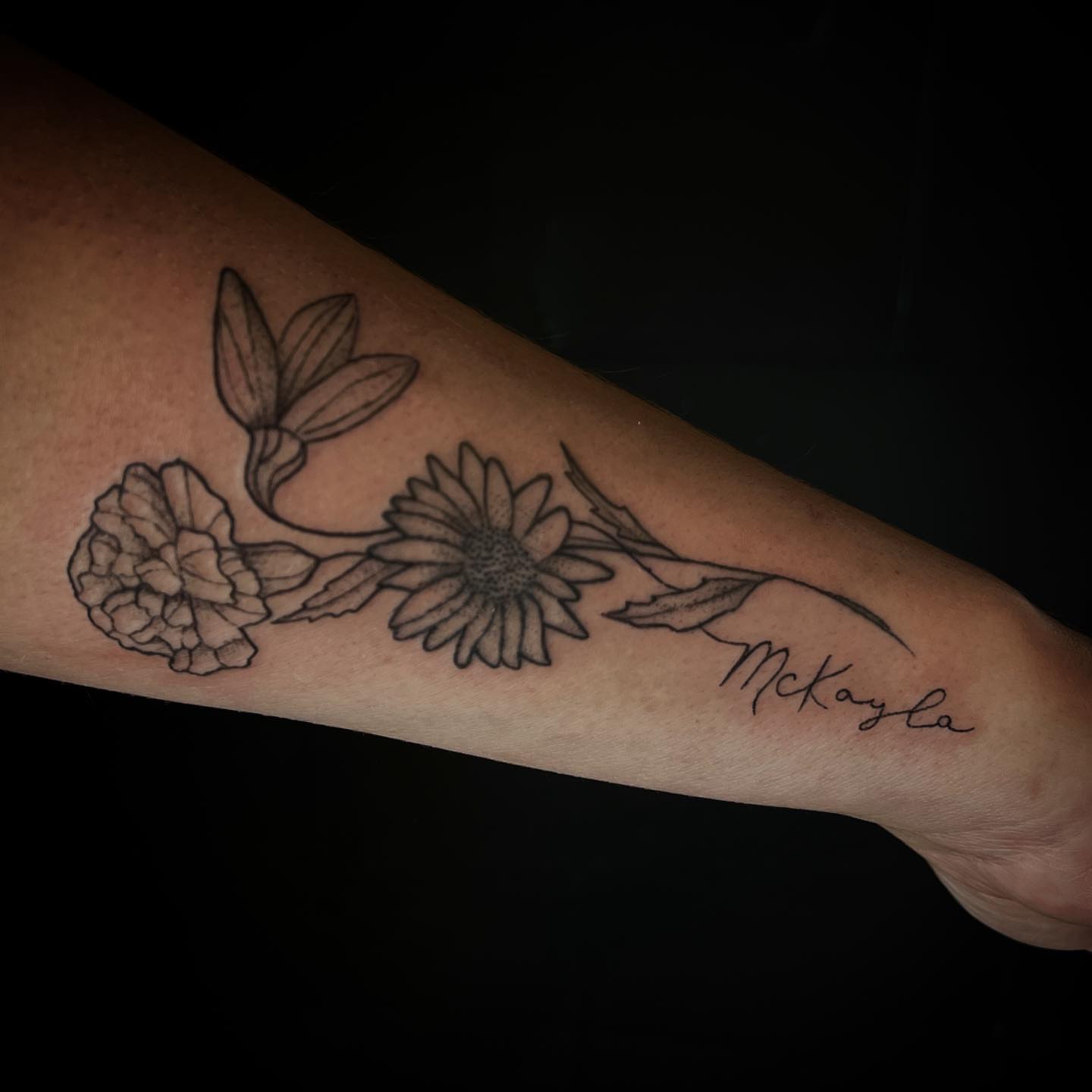 Flowers black and grey tattoo on the forearm by Angie Milano