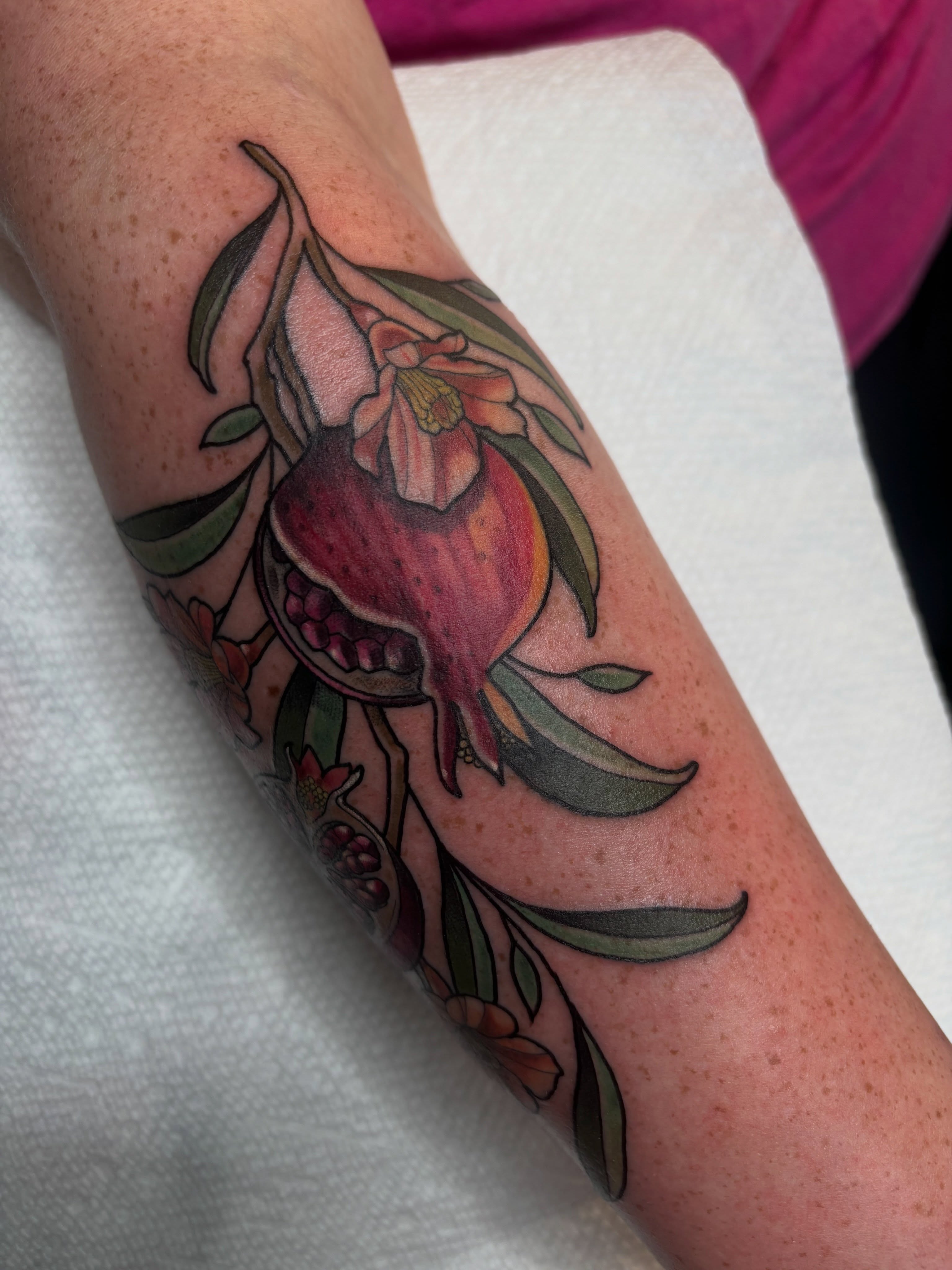 Pomegranate and flowers neo-traditional tattoo on the forearm by š¤Madeline Kristenš¤, Somerset, Wisconsin