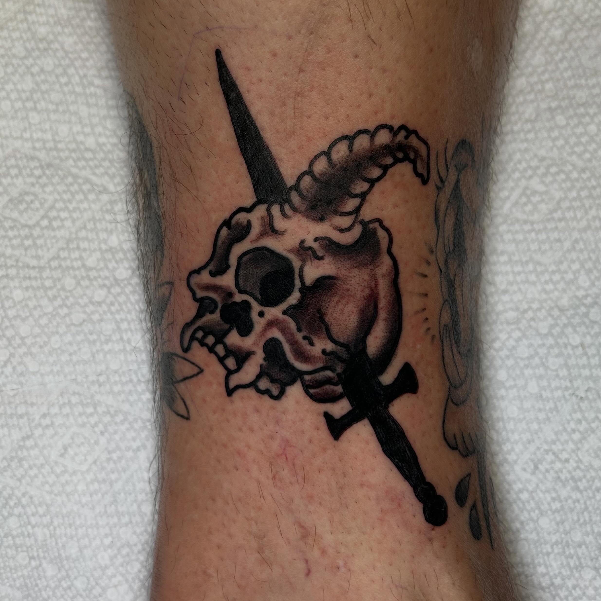 Skull and dagger black and grey tattoo on the forearm by Casey Lewis - Tattoo Artist, Cleveland Ohio