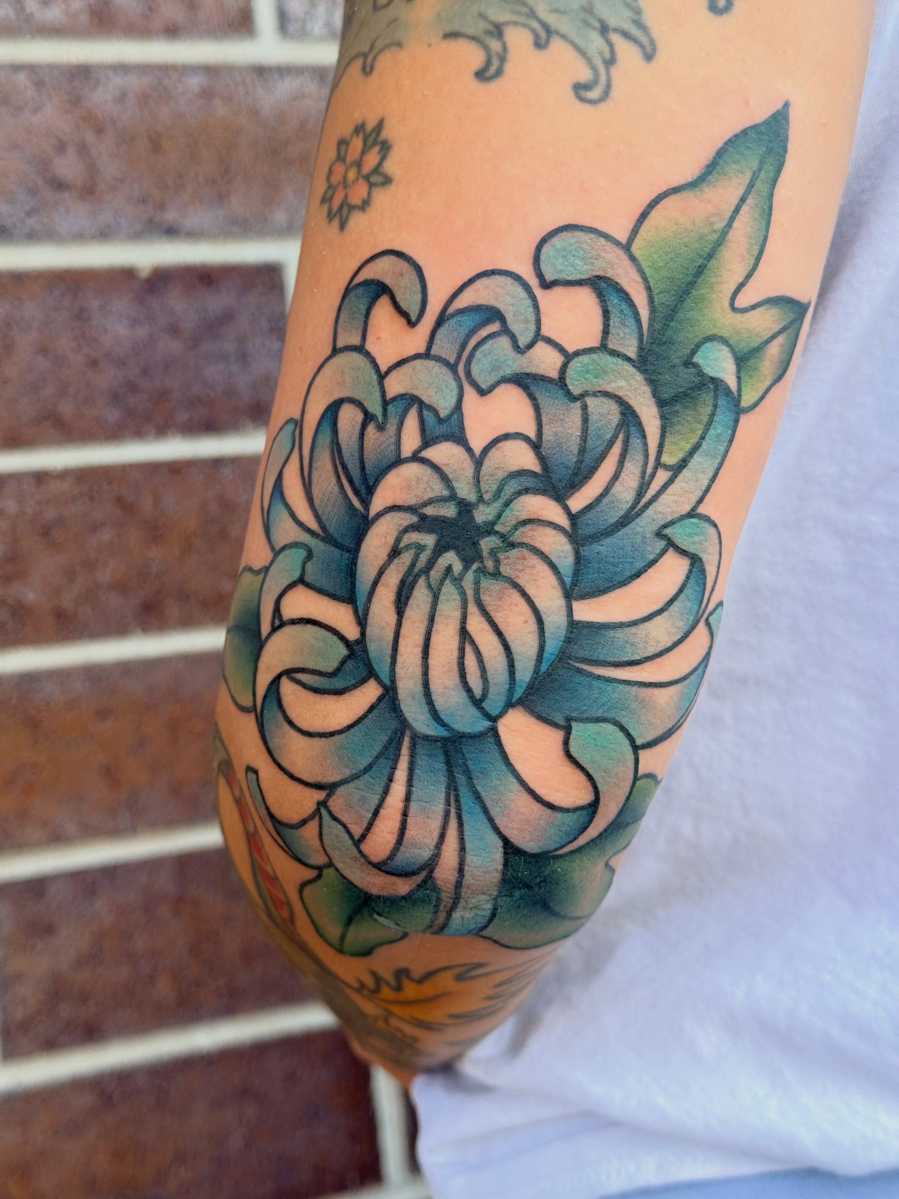 Chrysanthemum japanese irezumi tattoo on the forearm by Kelsey Louis, Iowa City, Iowa