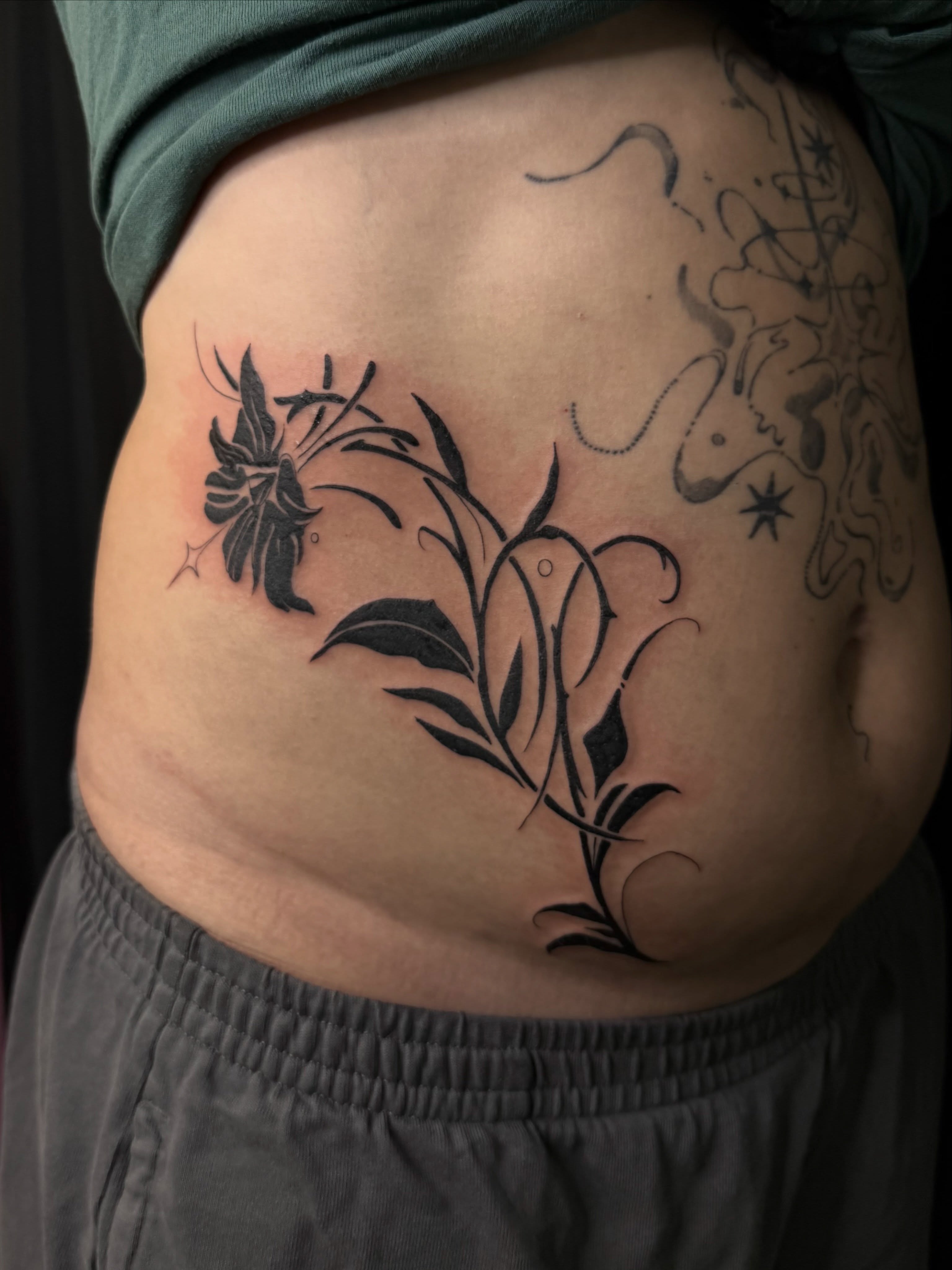 Floral design black and grey tattoo on the torso by ✧˖° mitch ✧˖°