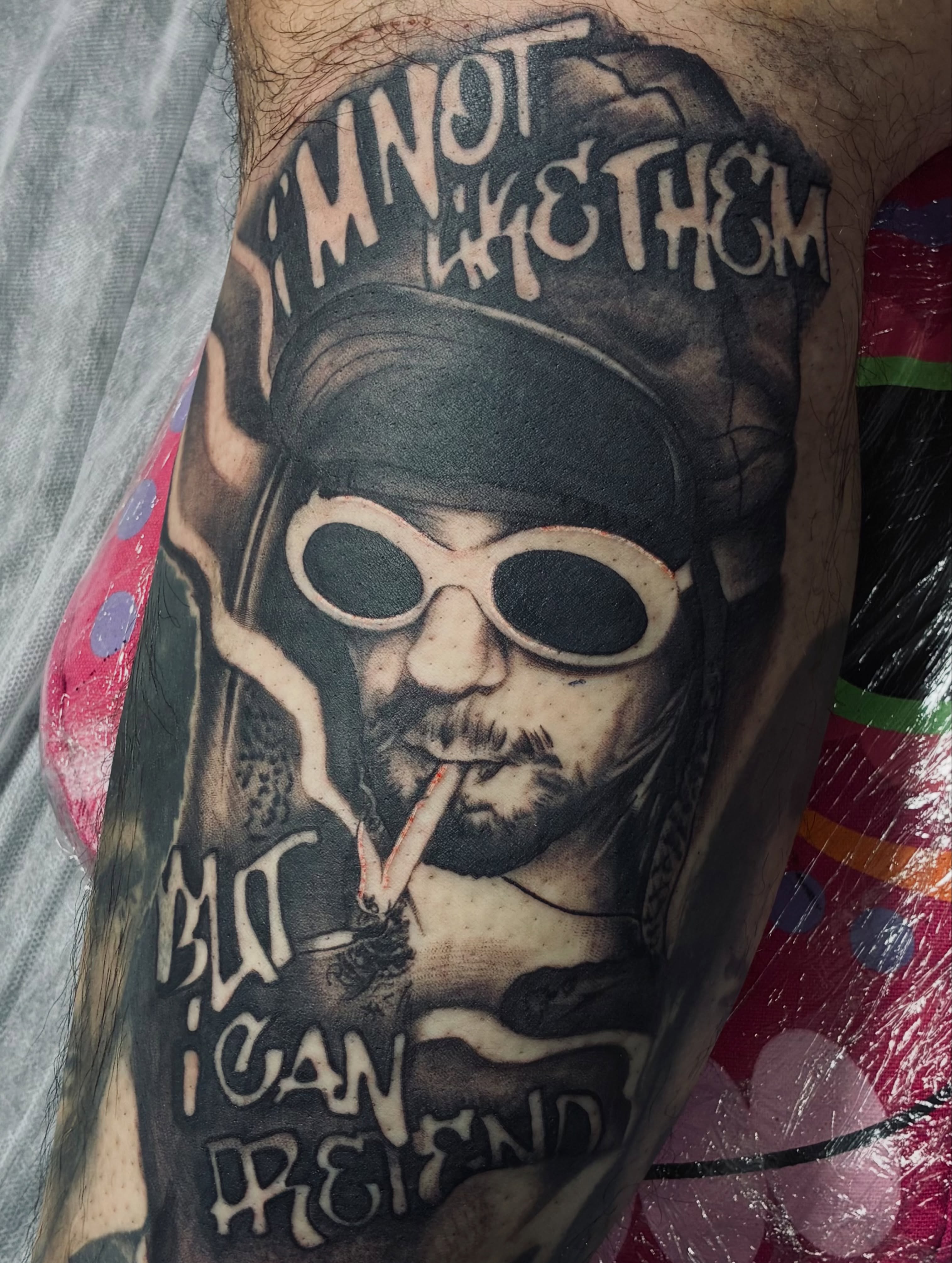 Smoking man with sunglasses realism tattoo on the forearm by Nessa, Las Vegas, Nevada