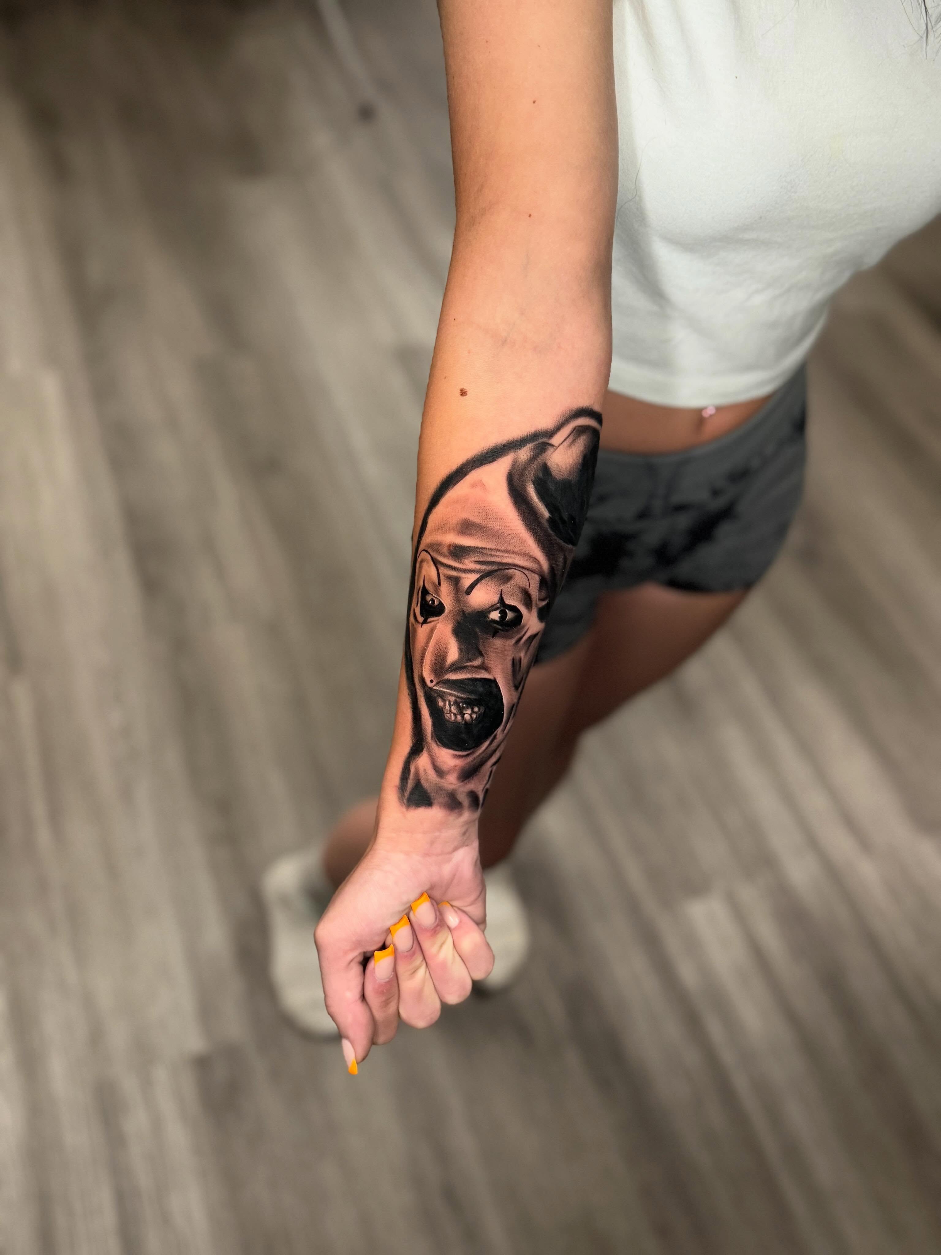 Horror face realism tattoo on the forearm by Adrián Banuelos
