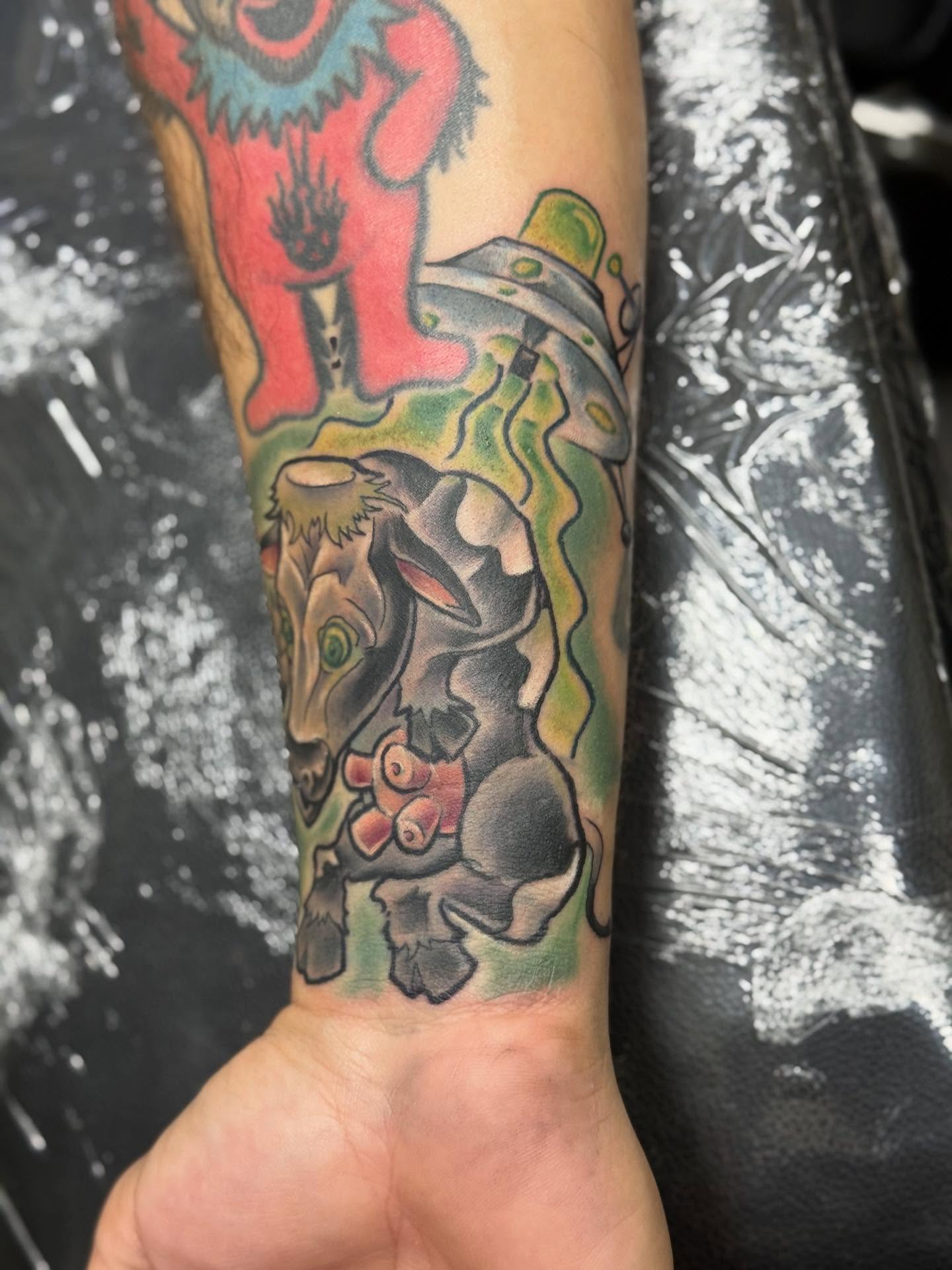 Dog with flower American traditional tattoo on the forearm by Damian James