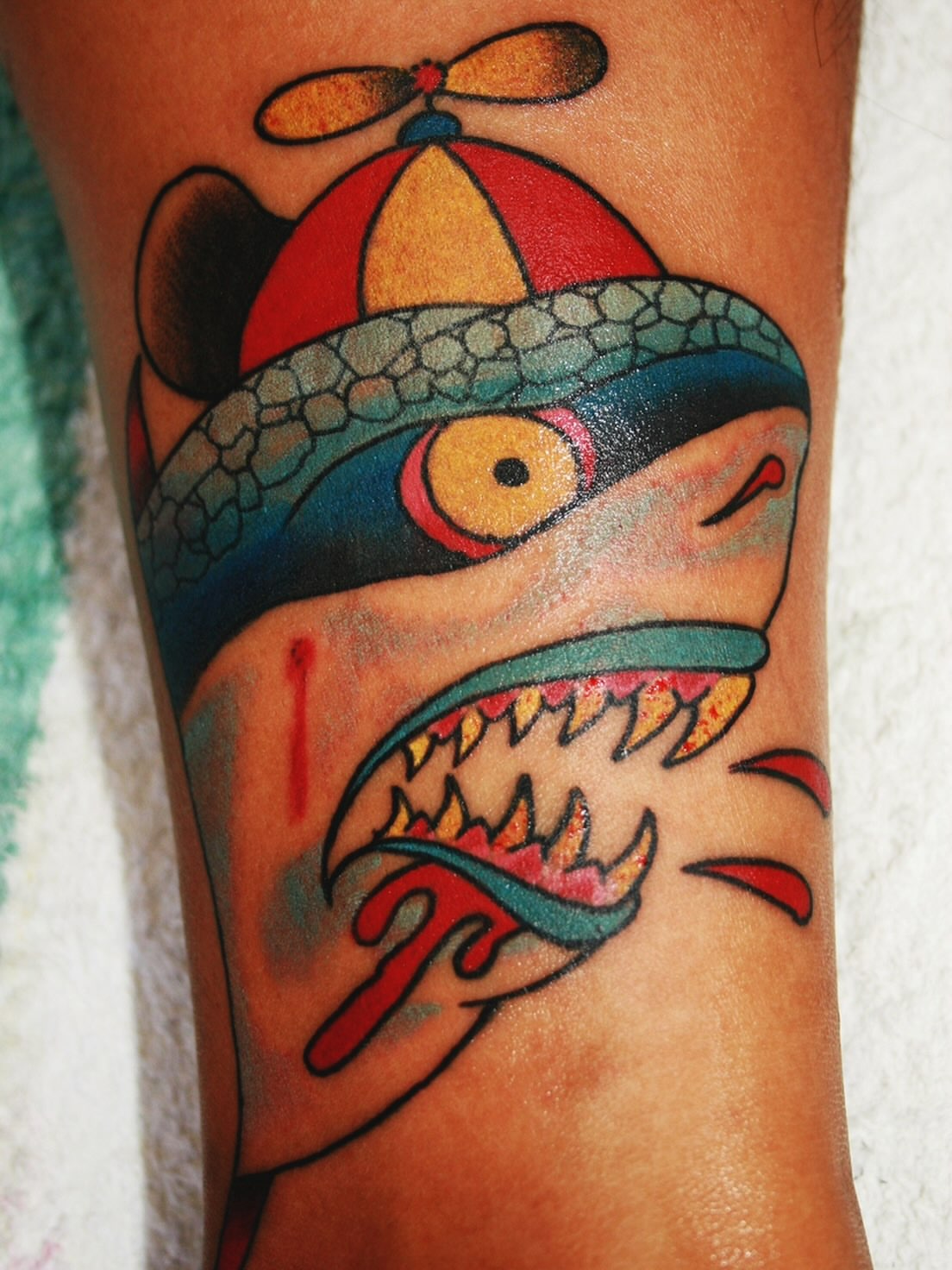 Shark with hat American traditional tattoo on the forearm by El Kapitan