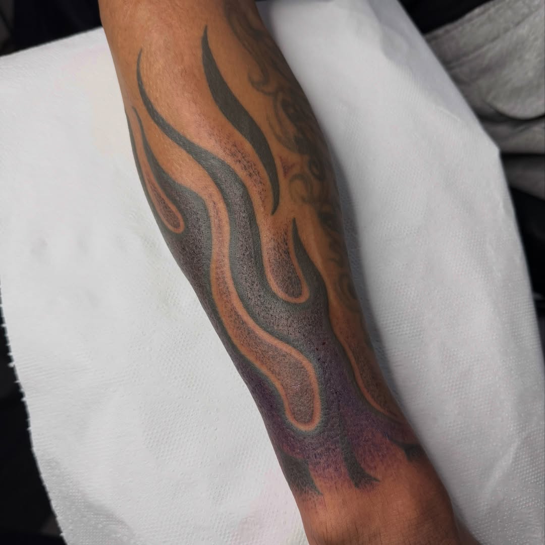 Flame Chicano tattoo on the forearm by Aiden Shaw