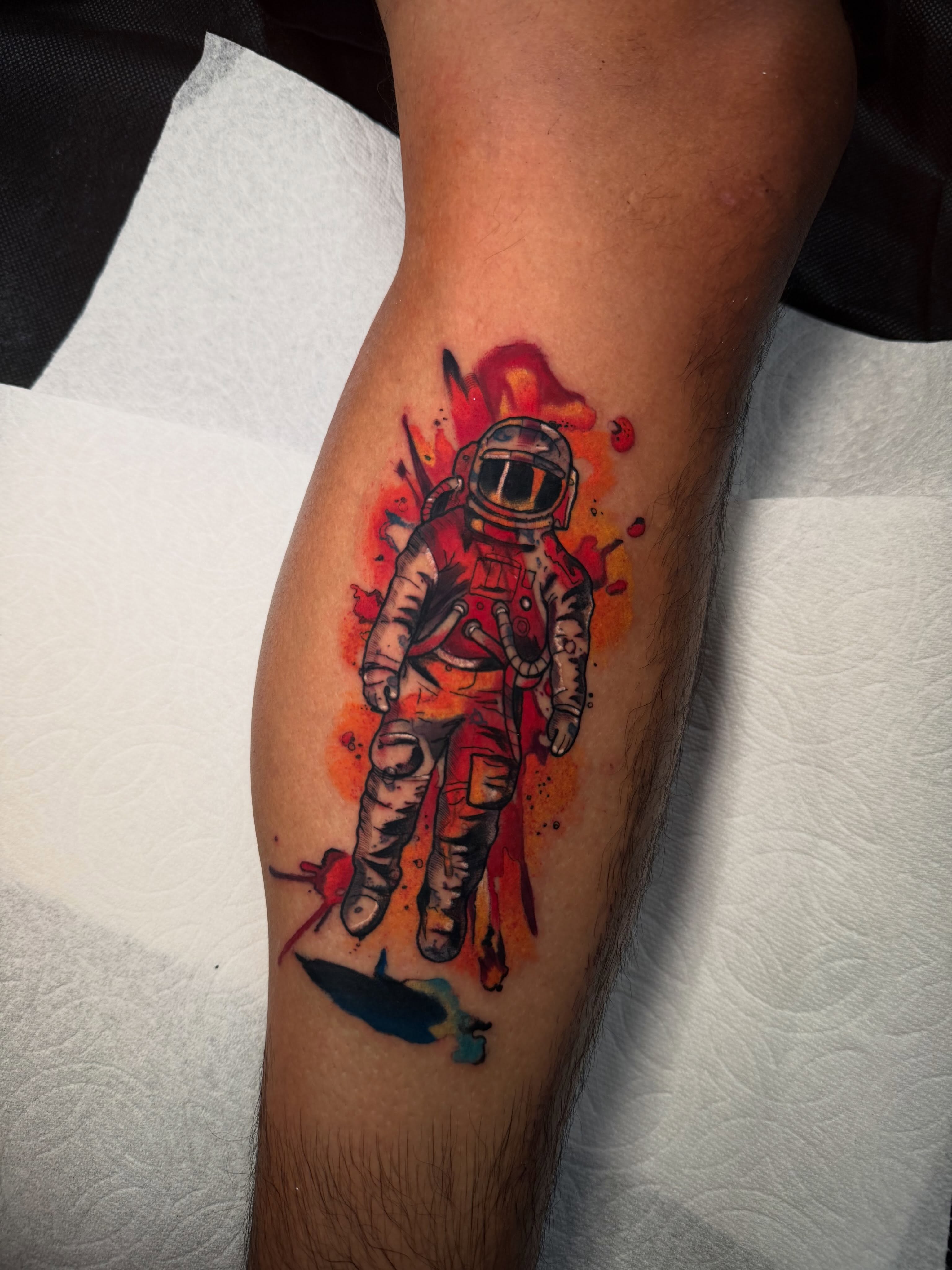 Astronaut watercolor tattoo on the forearm by Kenneth Ruiz
