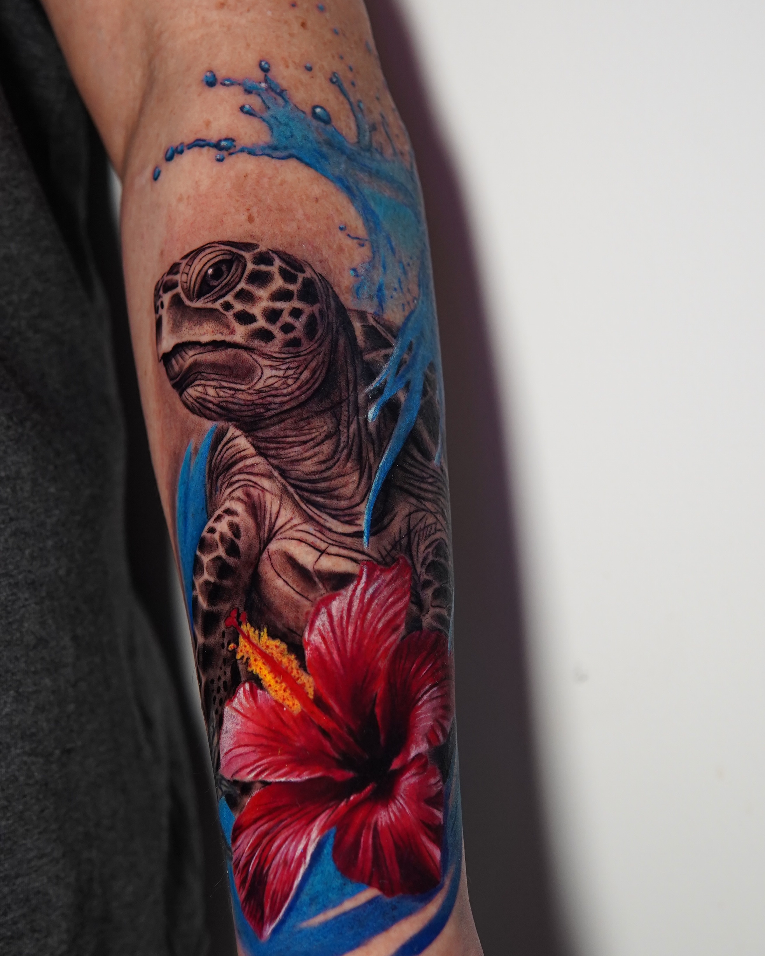 Turtle and hibiscus realism tattoo on the forearm by Marissa S., Lansing, Michigan
