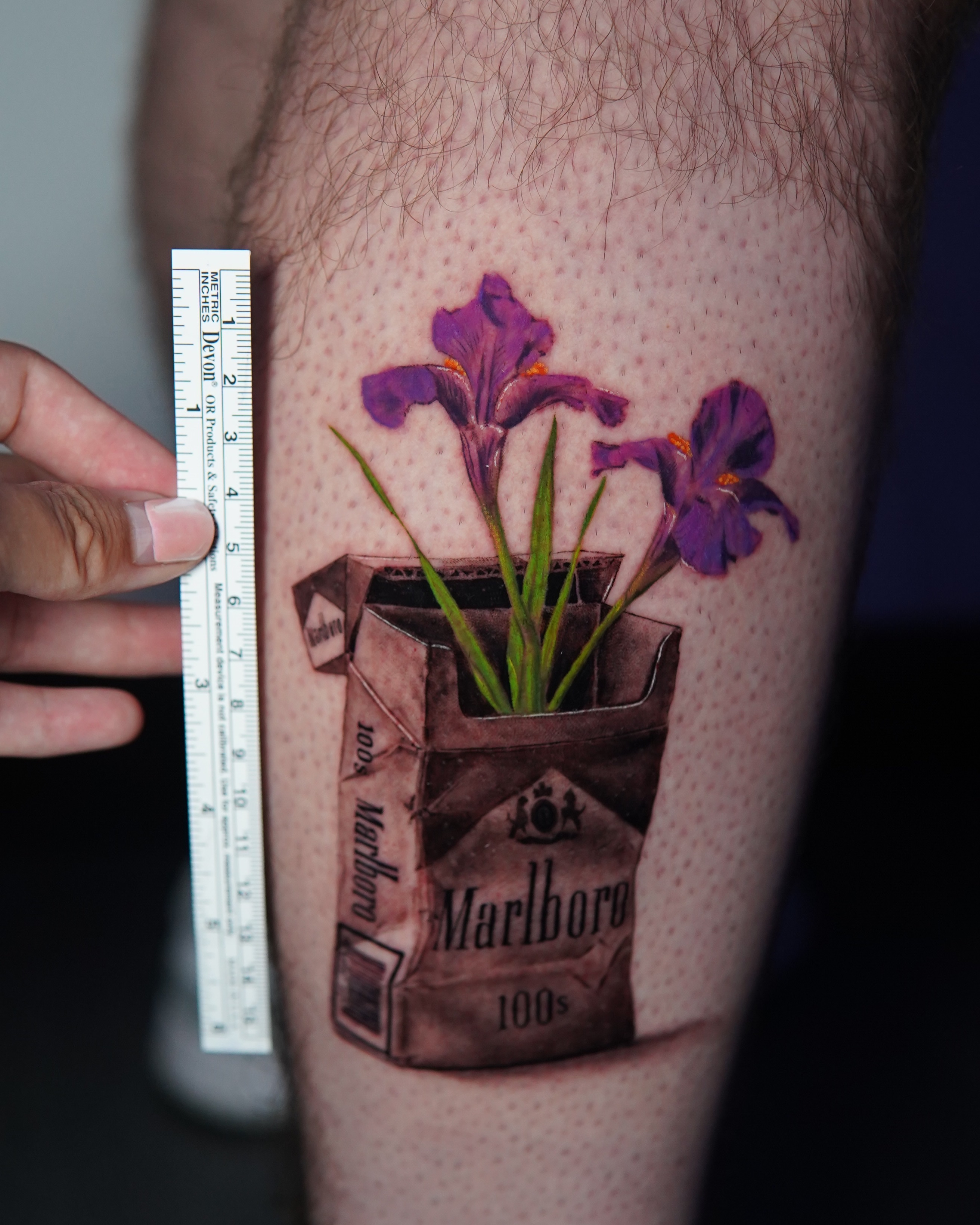 Purple iris flowers realism tattoo on the thigh by Marissa S., Lansing, Michigan