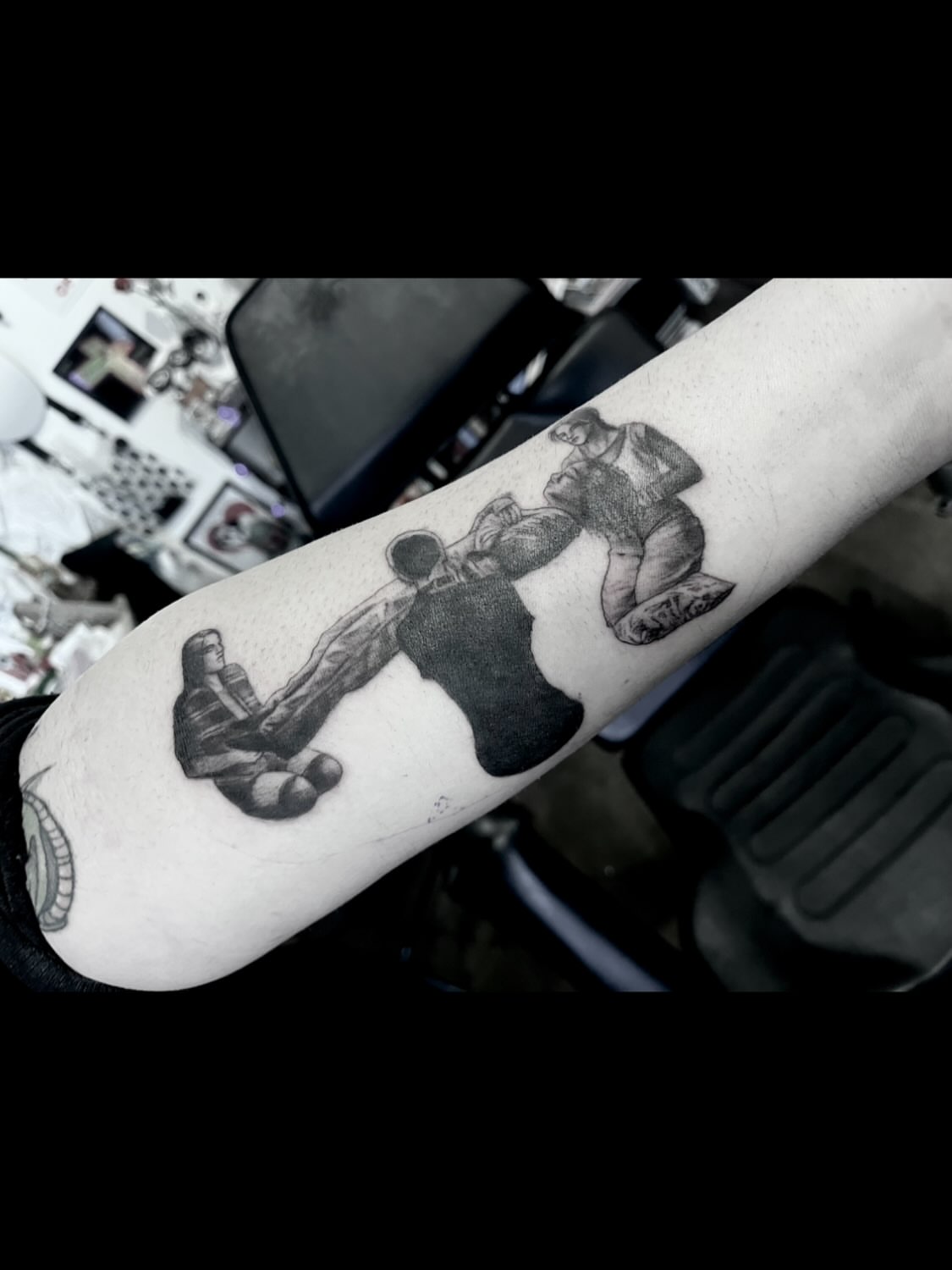Boxing match black and grey tattoo on the forearm by Nathan Esteras
