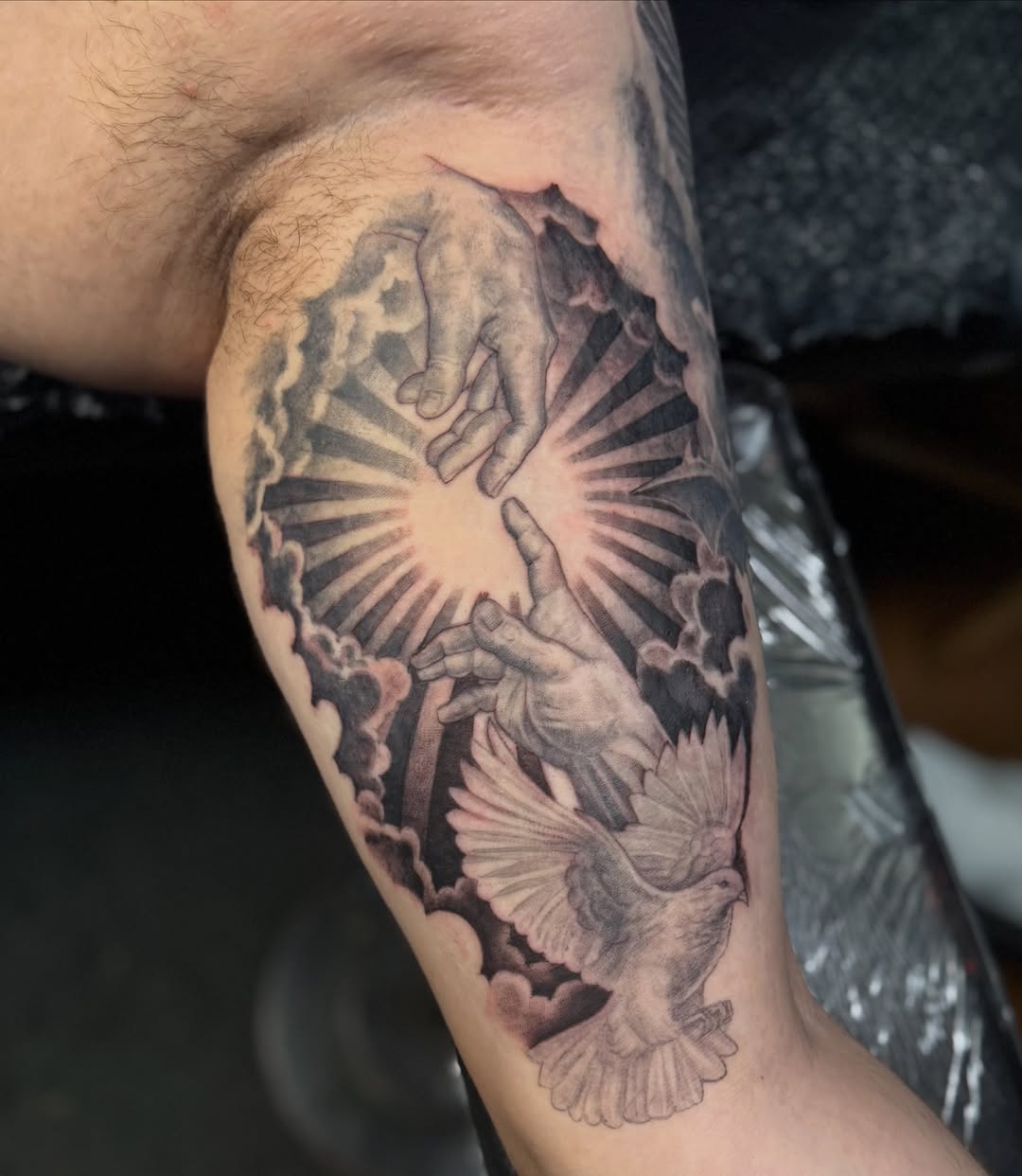 Hands and dove realism tattoo on the forearm by JT Ink