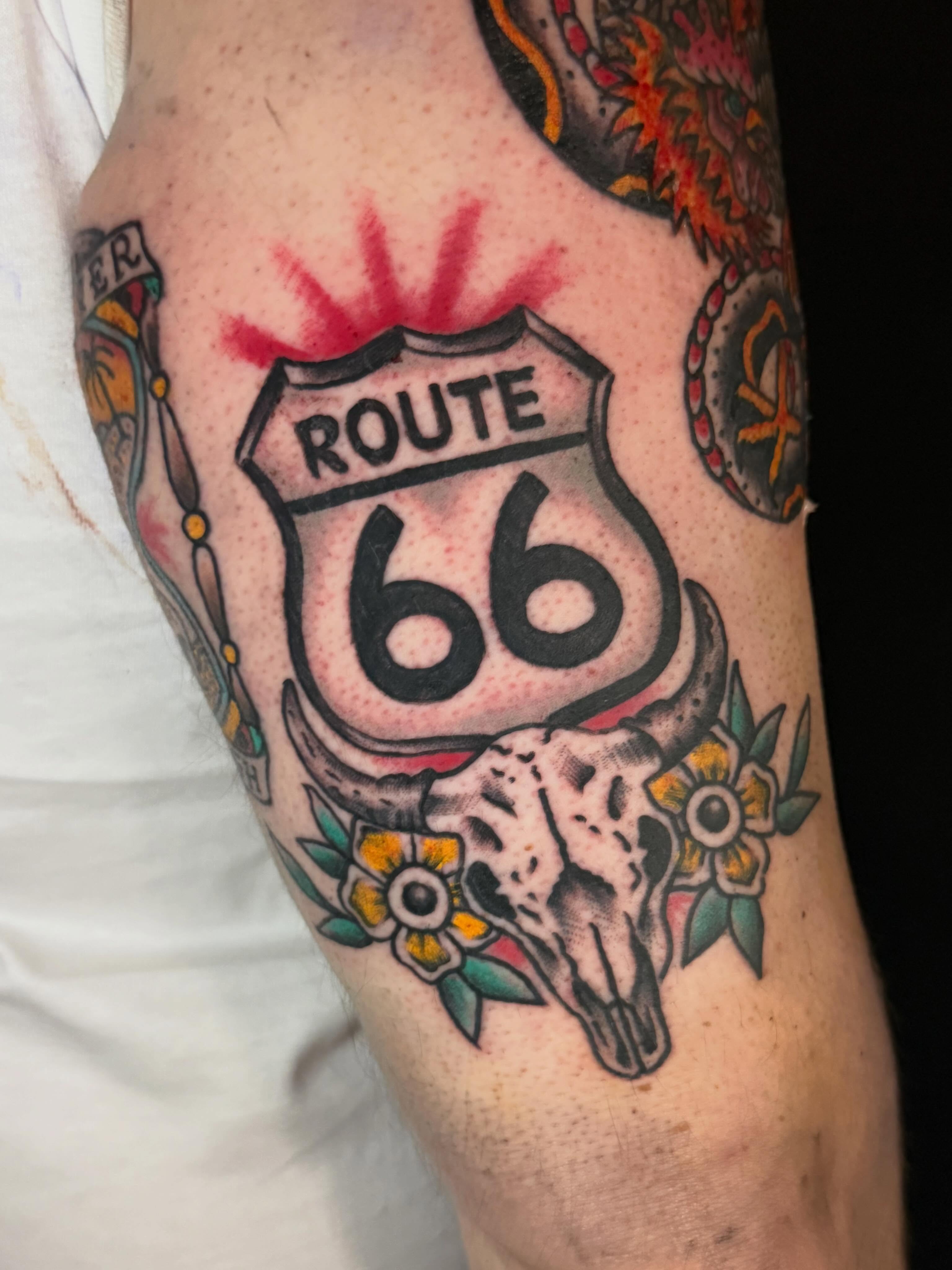 Route 66 sign American traditional tattoo on the forearm by Jesse Boss, Nashville, Tennessee