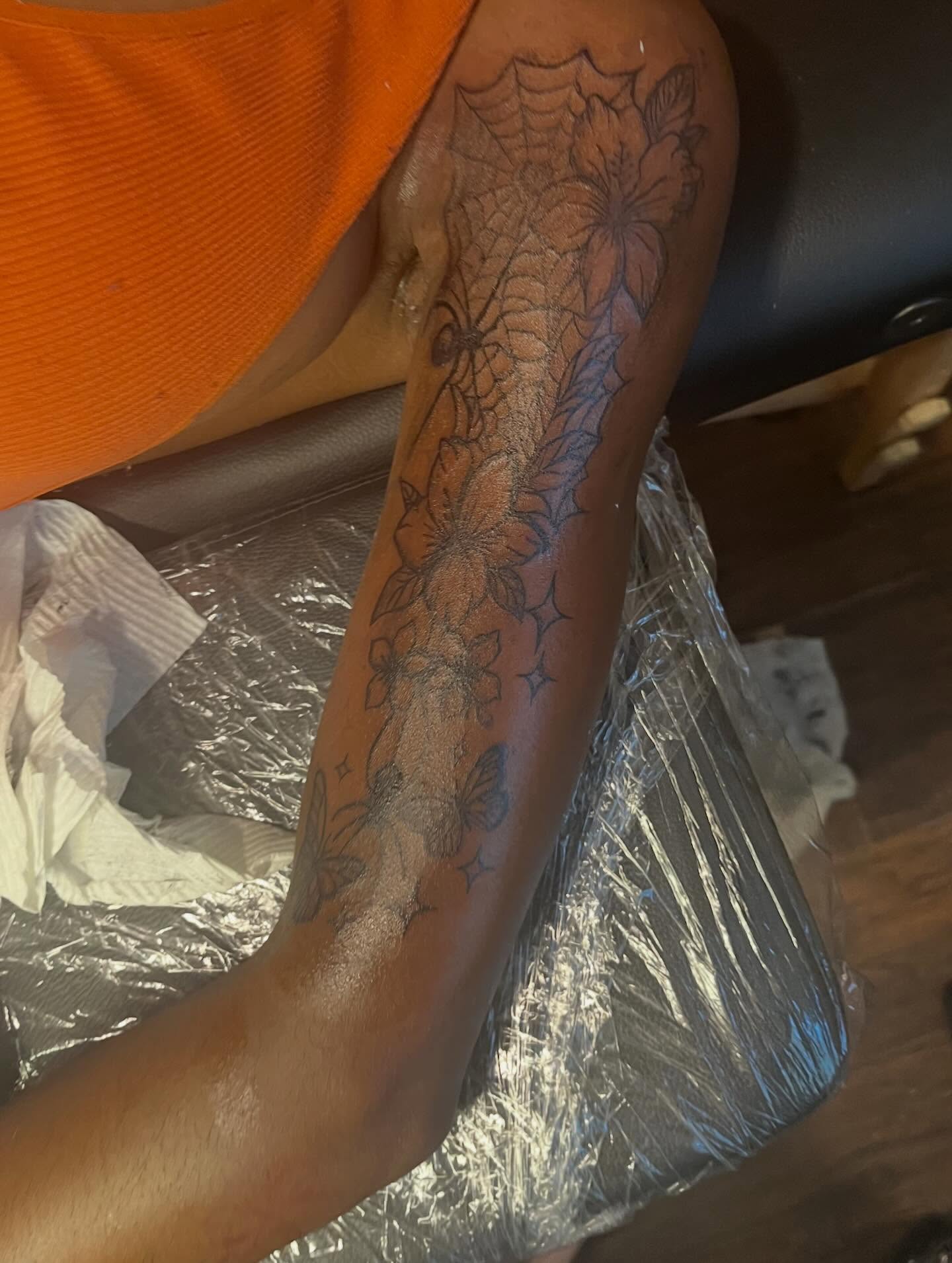Spiderweb and flowers black and grey tattoo on the forearm by π Westside