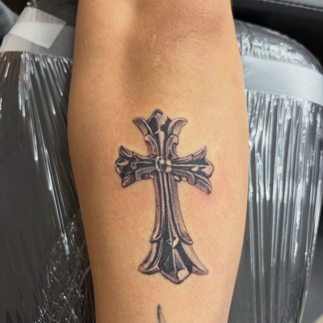 Cross black and grey tattoo on the forearm by Haley