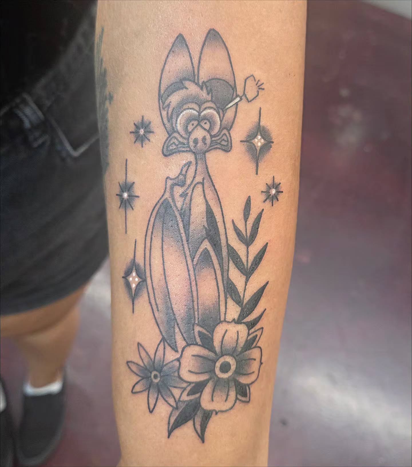 Bat with flowers black and grey tattoo on the forearm by Kat Coniglio Art
