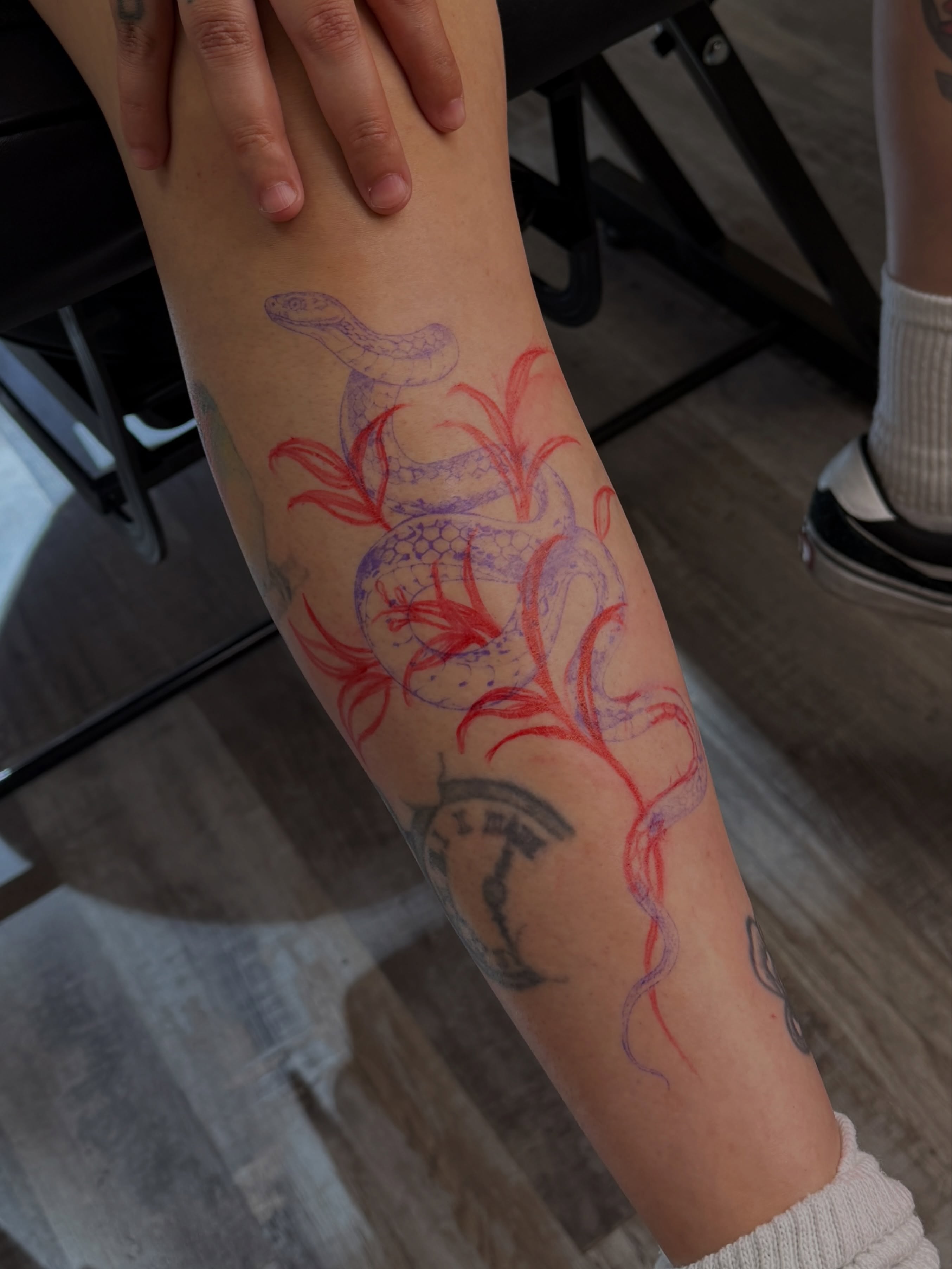 Snake and peony new school tattoo on the forearm by Laura Gomez Tattoos