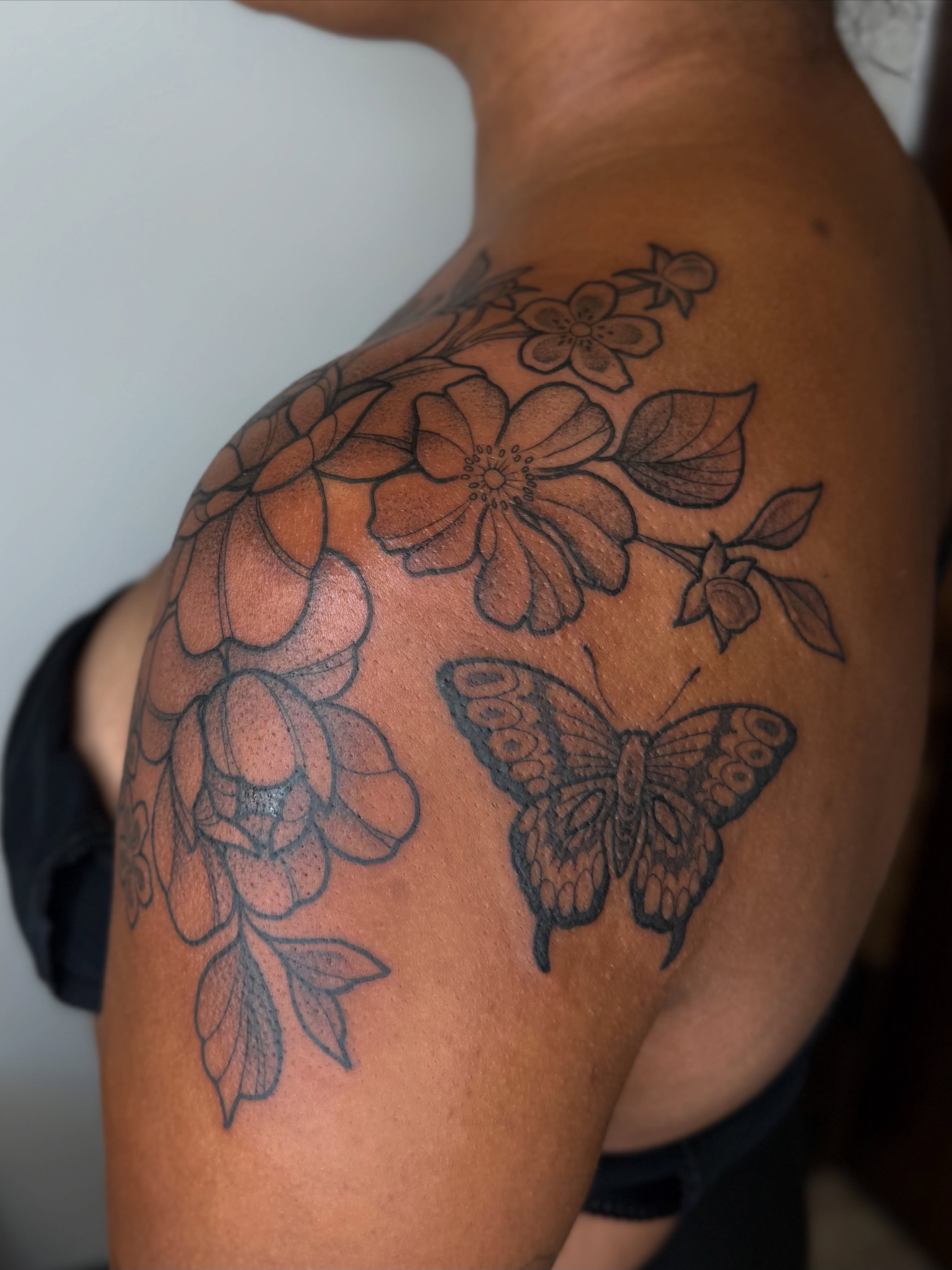 Flowers and butterfly black and grey tattoo on the shoulder by Emma Friesen - Lancaster & York Tattoo Artist, Lancaster, Pennsylvania