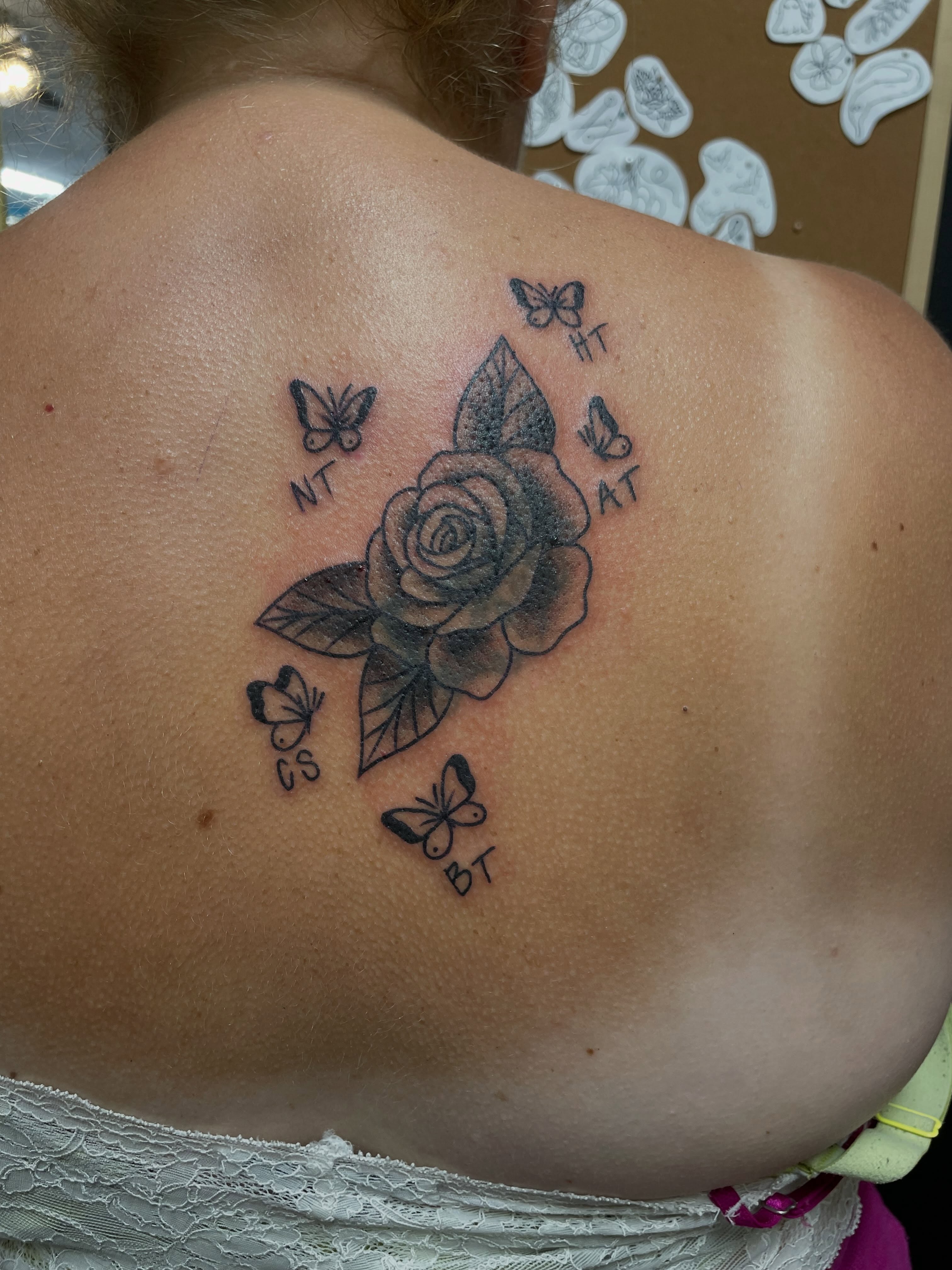 Rose with butterflies black and grey tattoo on the back by Mallory Moore