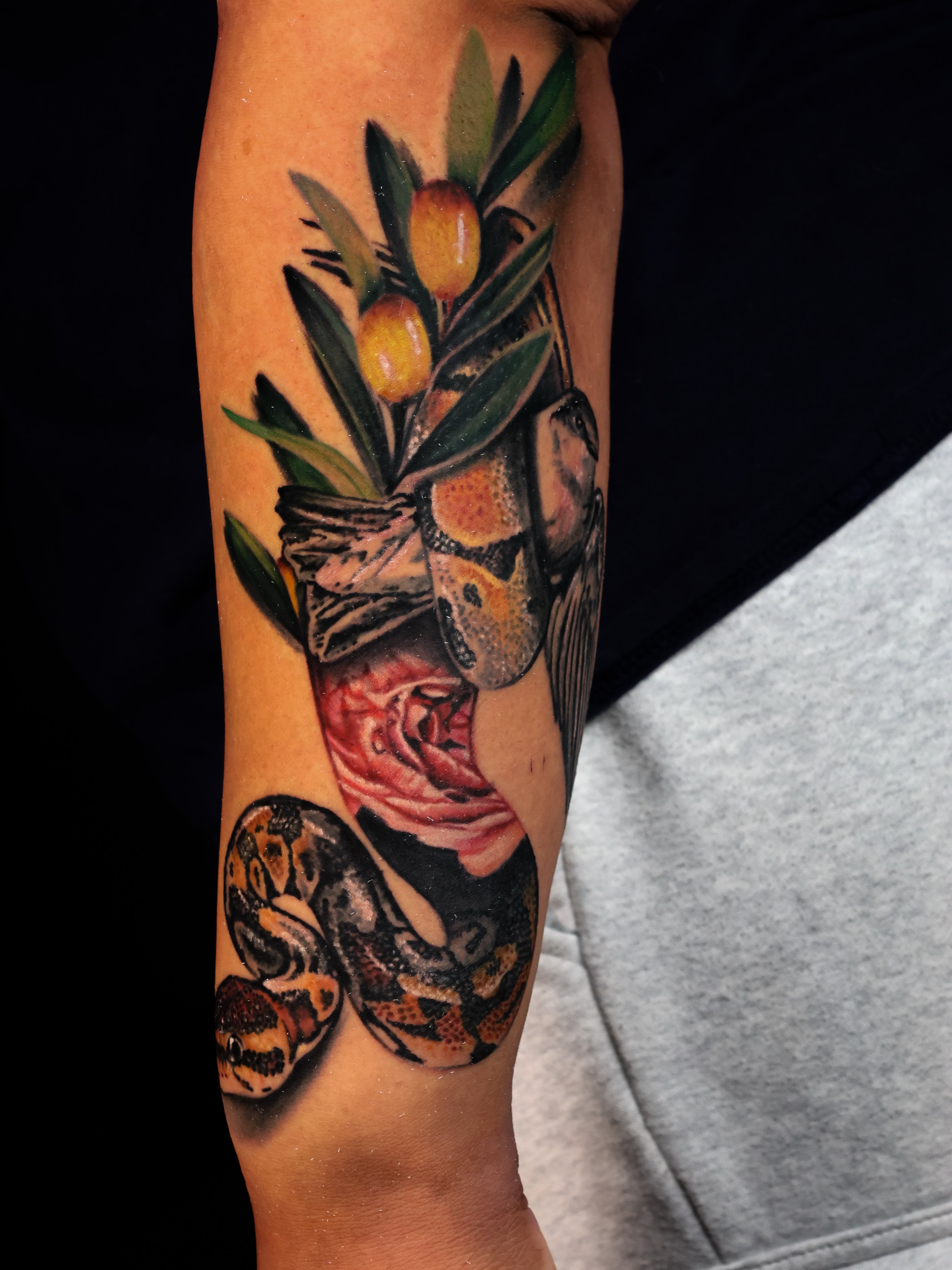 Snake and peony realism tattoo on the forearm by Ciani Holman