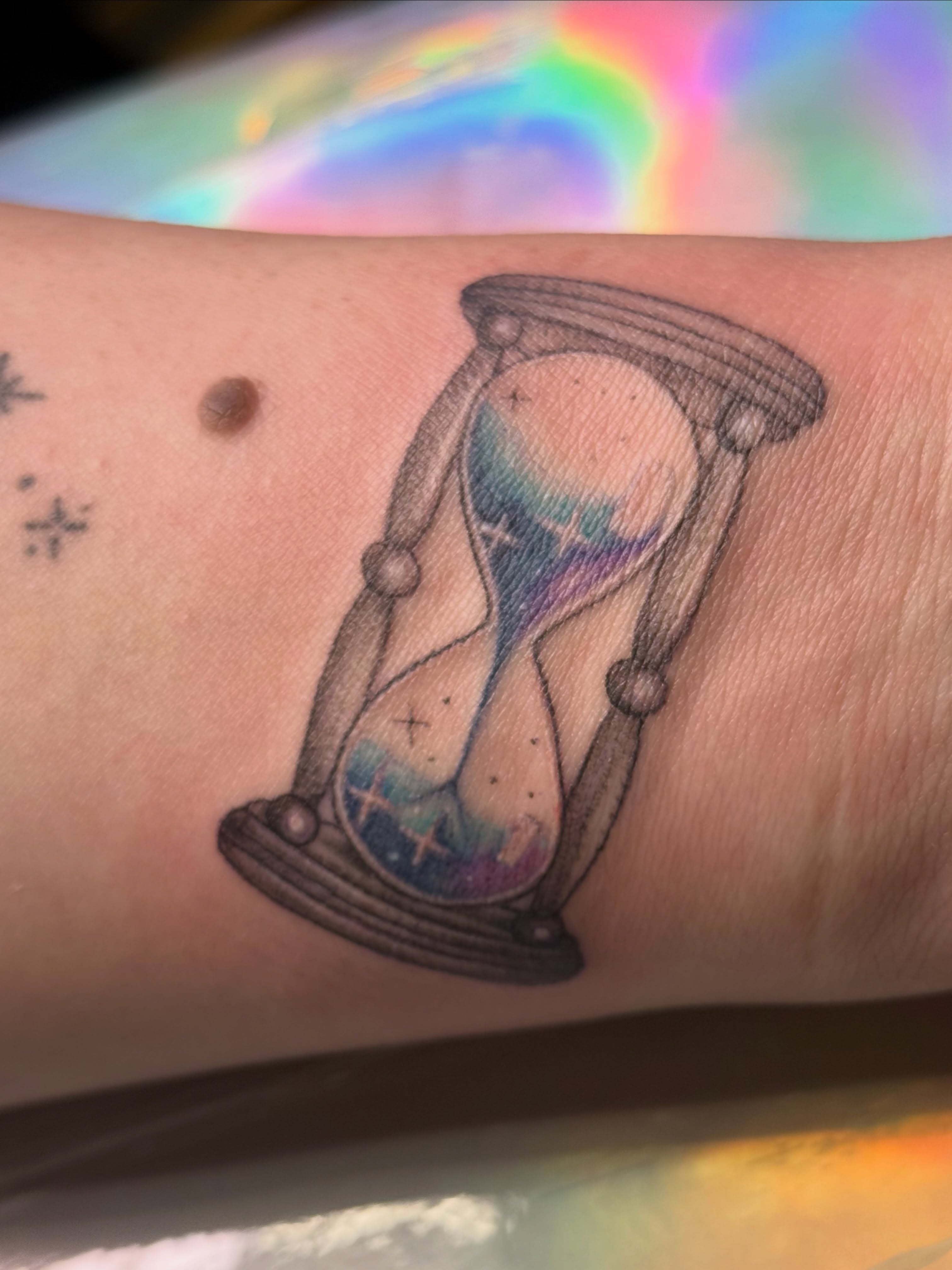 Hourglass dotwork tattoo on the forearm by Alexx Colombo