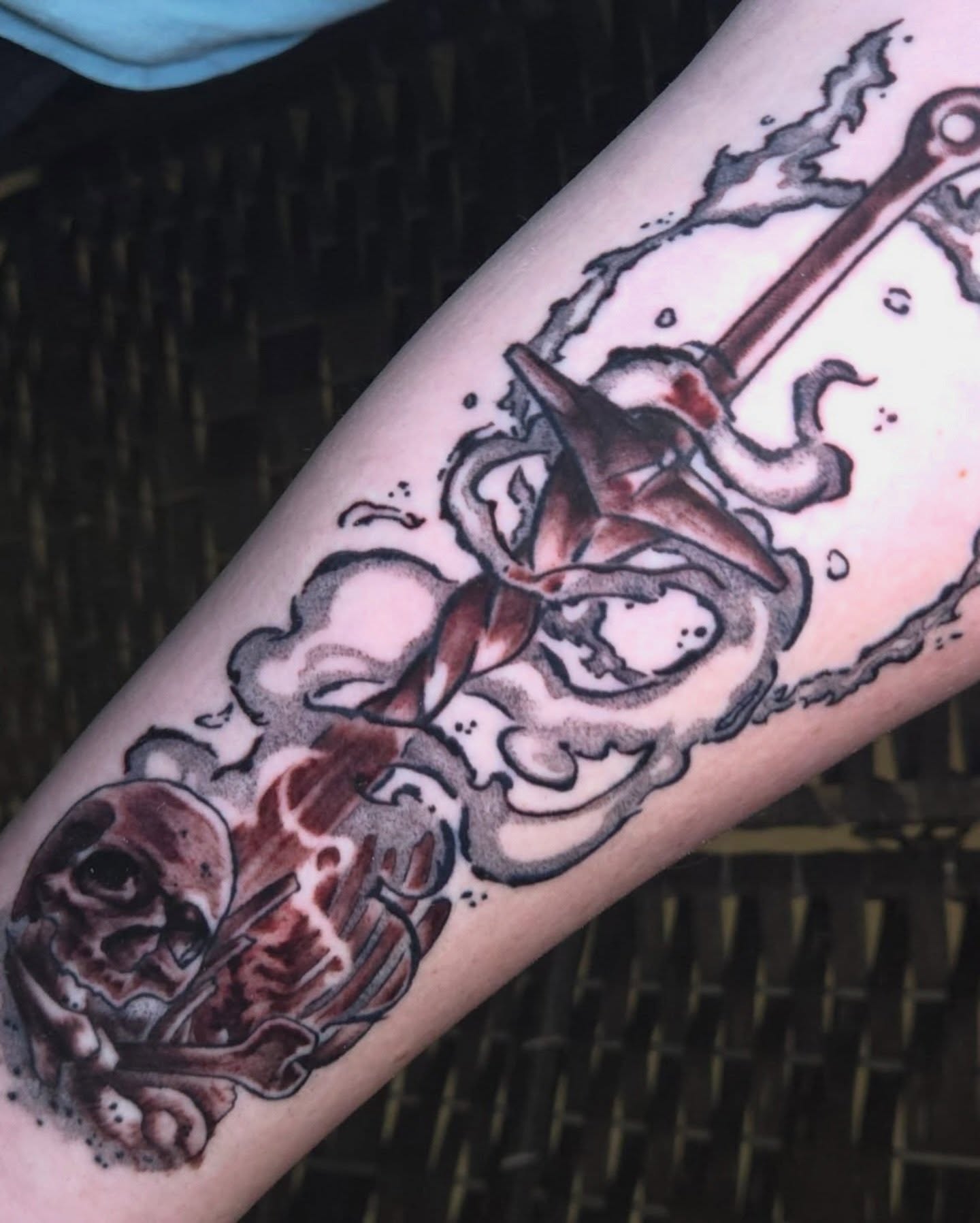 Skull and anchor American traditional tattoo on the forearm by Nic Mann