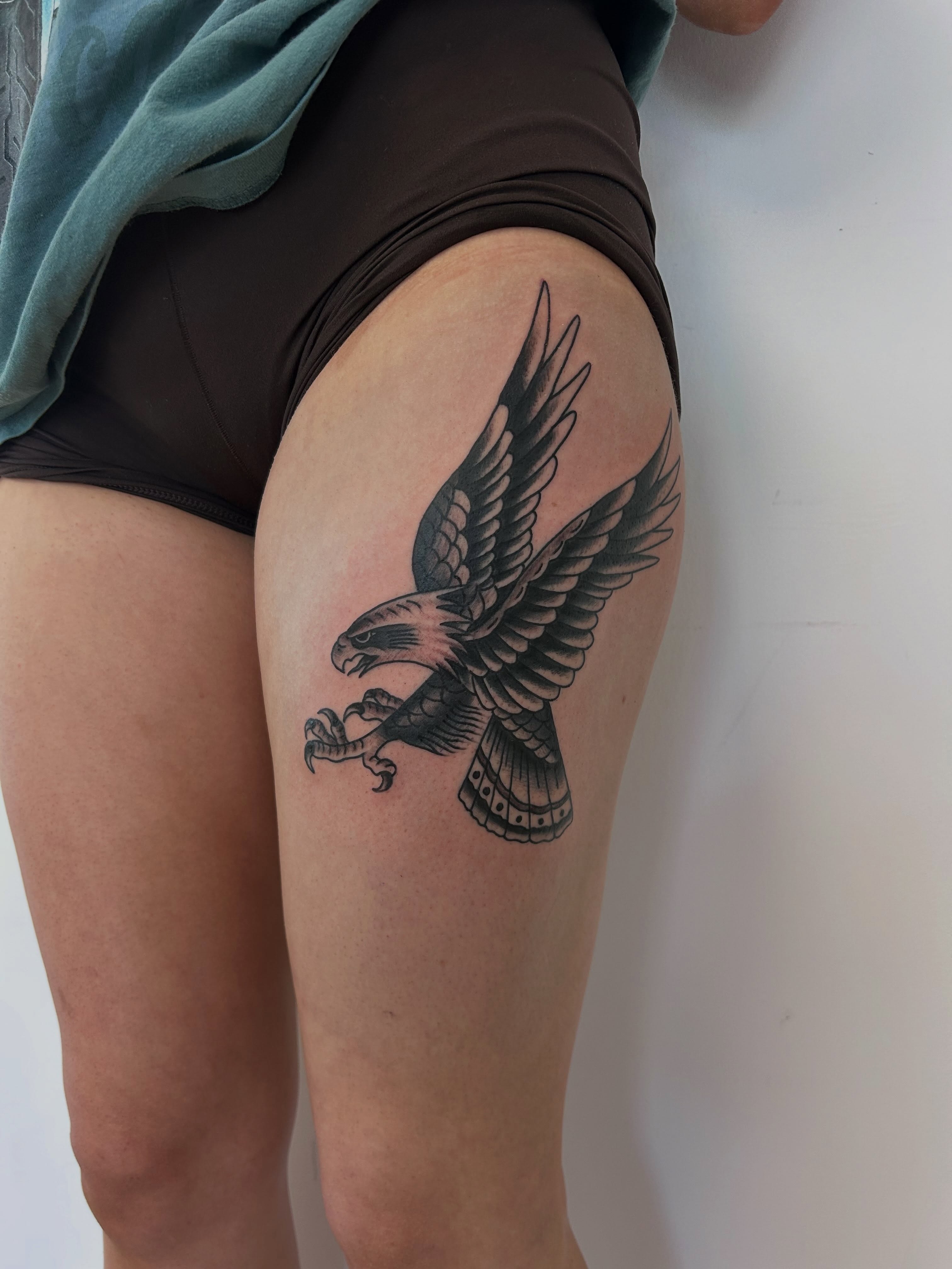 Eagle black and grey tattoo on the thigh by Alex Lang