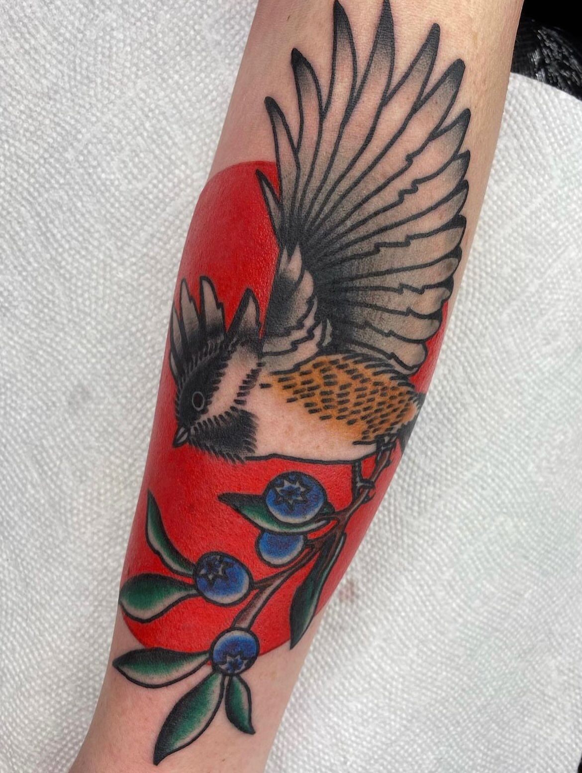 Bird and berries American traditional tattoo on the forearm by Alex Lang