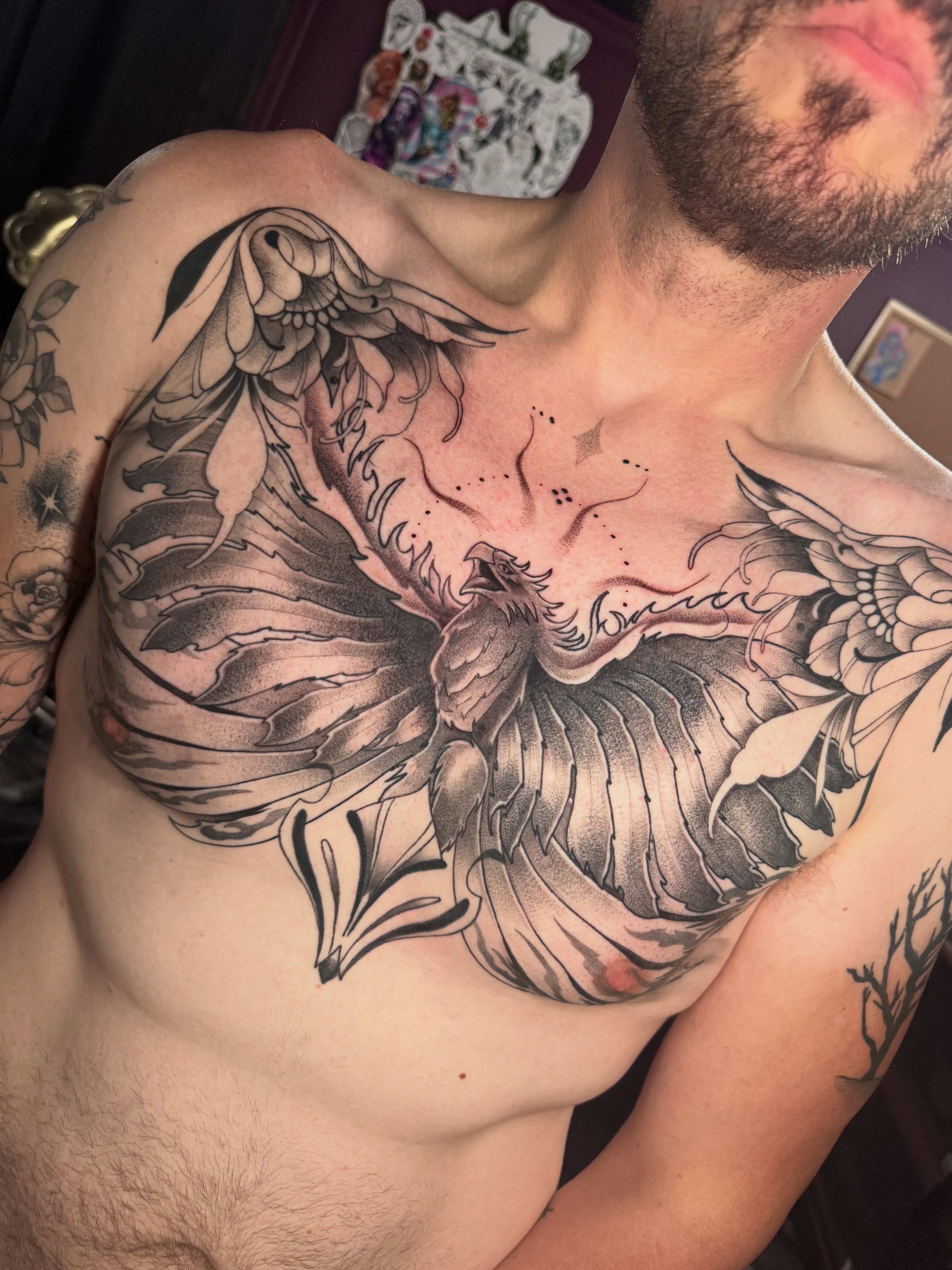Winged phoenix dotwork tattoo on the chest by Dante Singh
