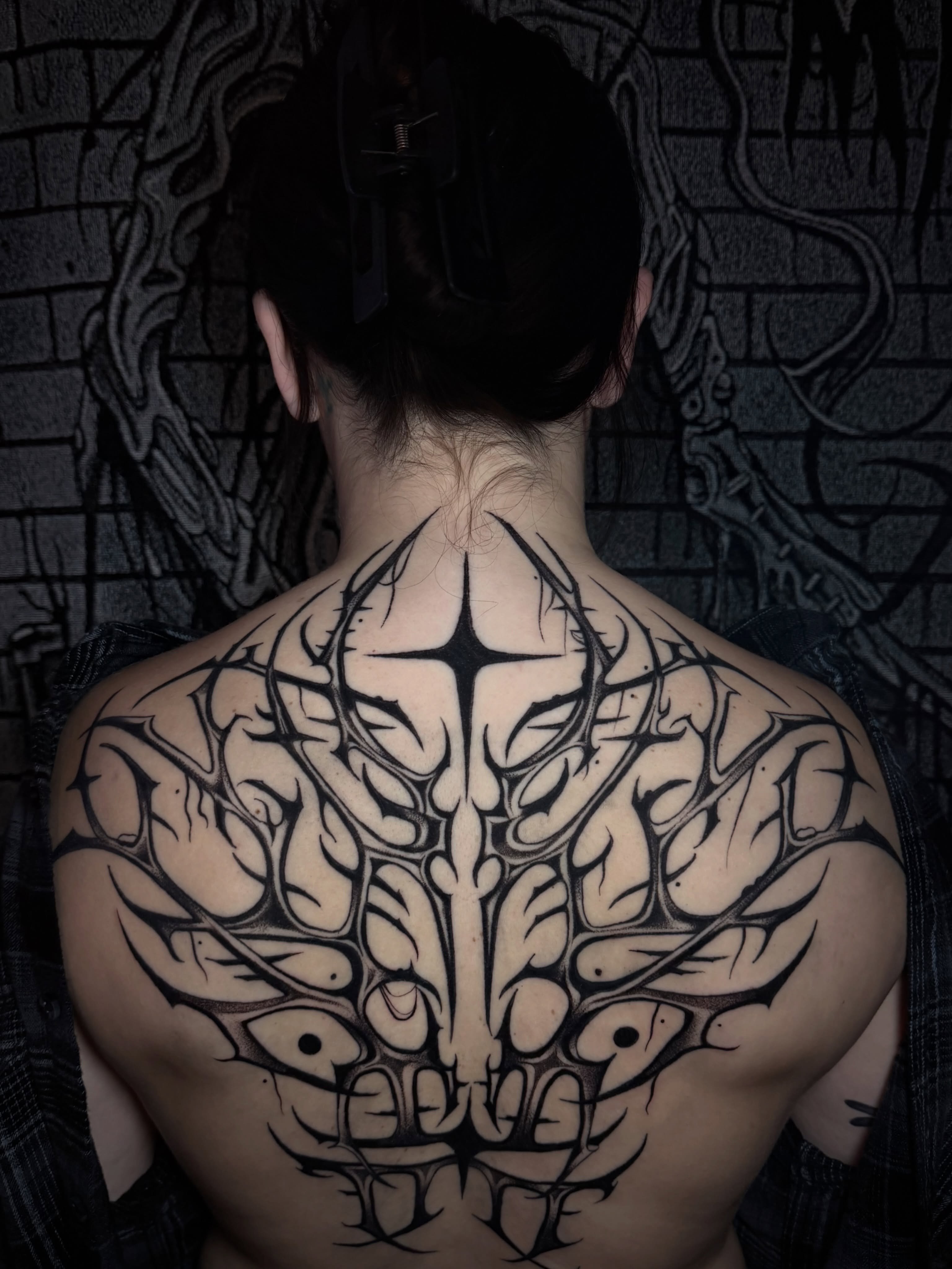 Spine tattoo tribal tattoo on the back by Marlee Natale, Pinellas Park, Florida