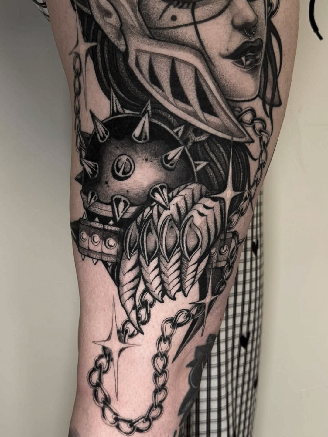 Woman's face with spiked helmet realism tattoo on the forearm by Tommy Sisneros