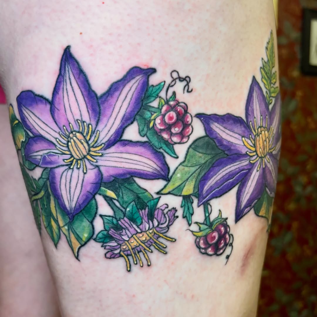 Purple clematis flowers watercolor tattoo on the thigh by Bekah Smith
