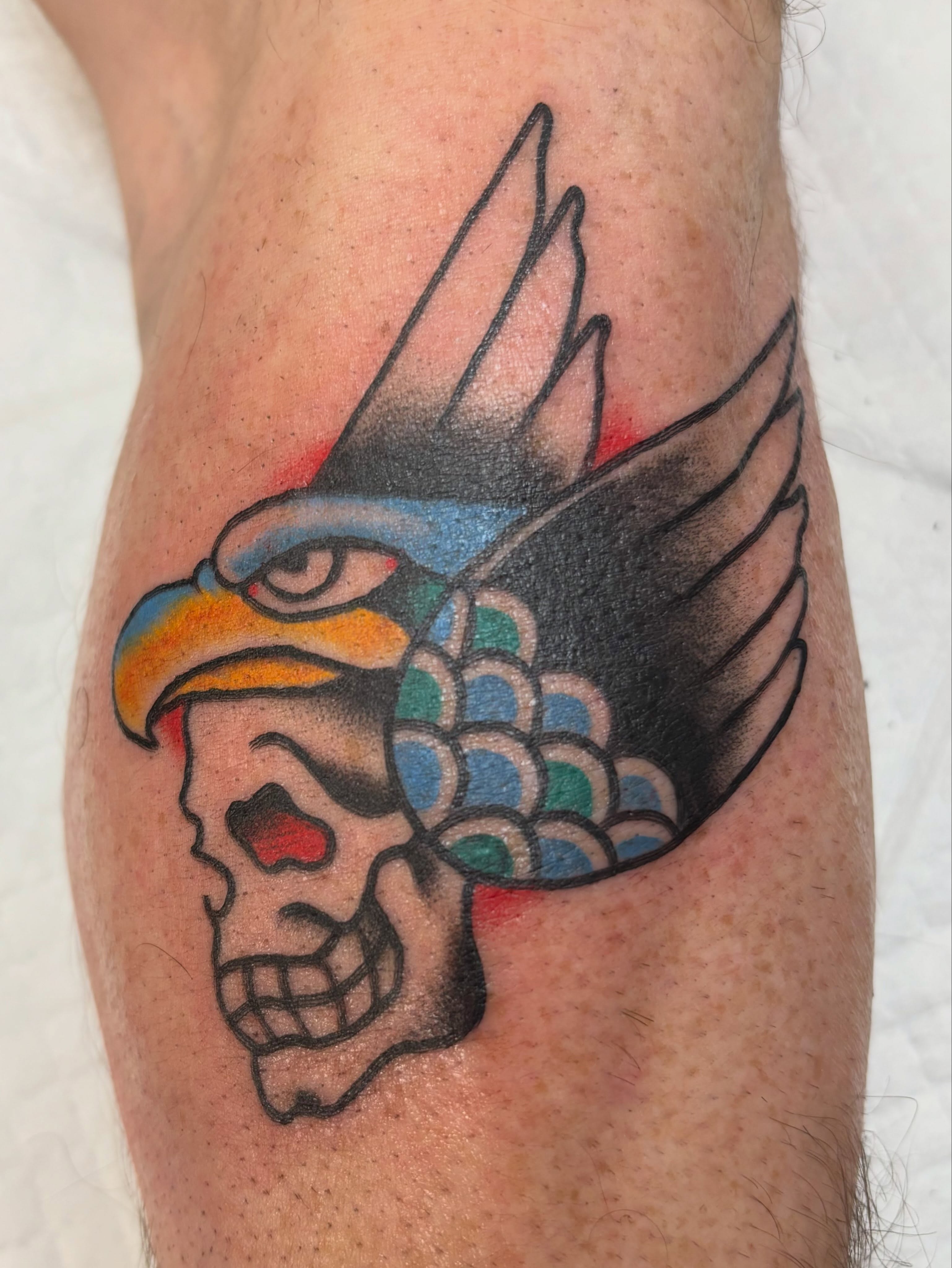Skull and eagle American traditional tattoo on the forearm by Nick Tate