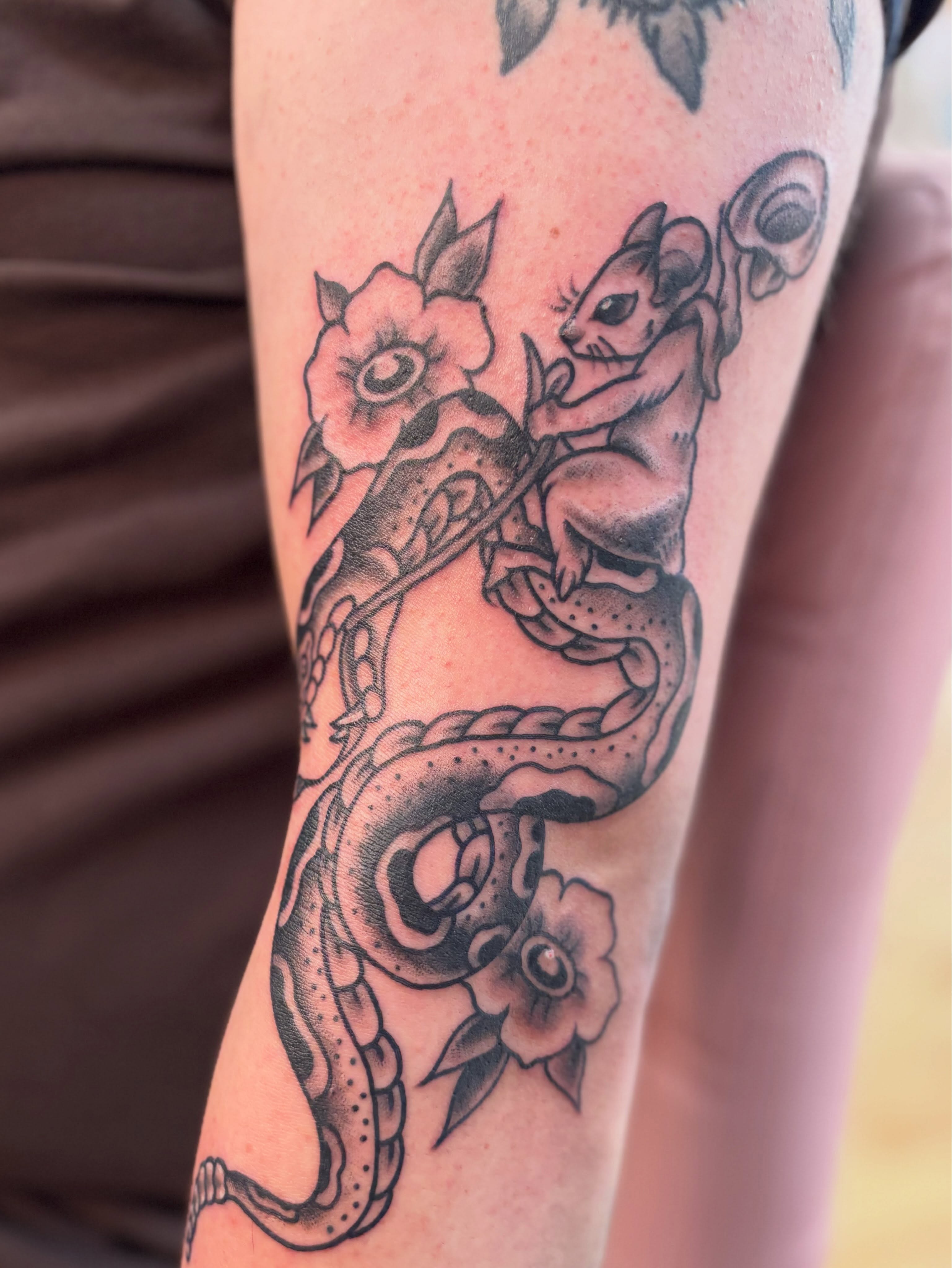 Snake and mouse American traditional tattoo on the forearm by Nick Tate