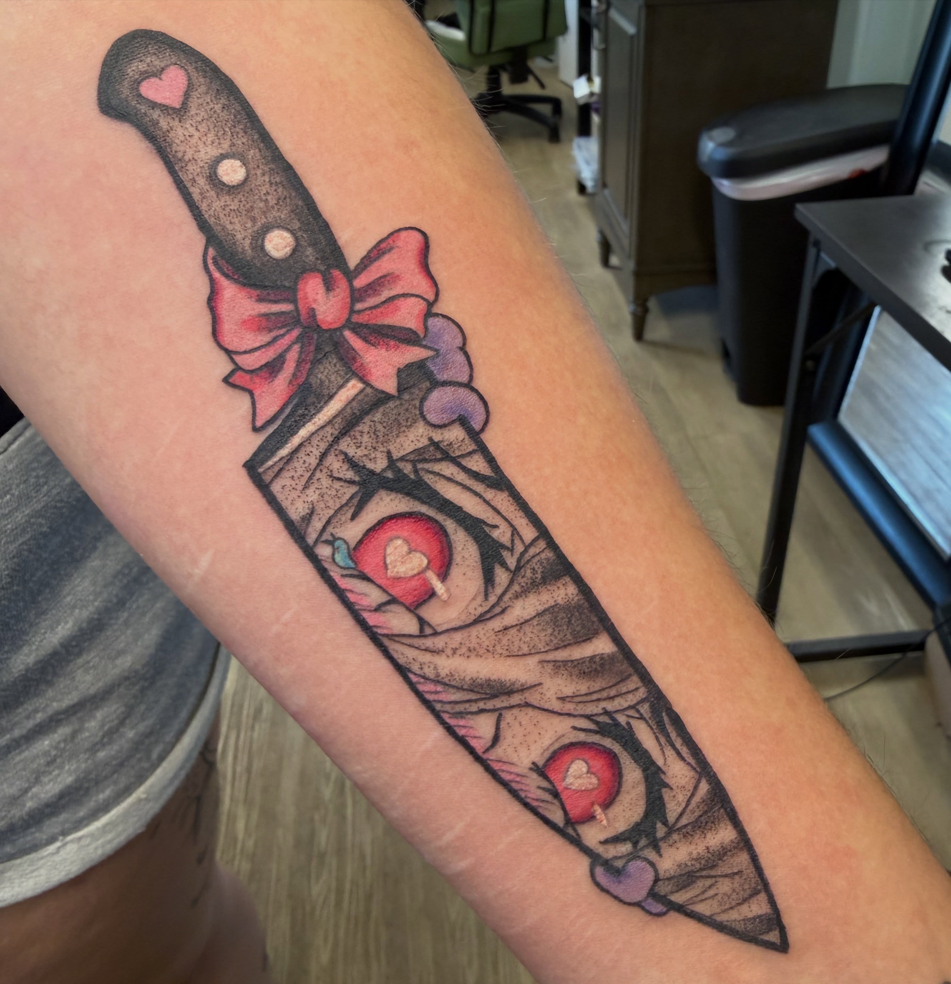 Knife with bow American traditional tattoo on the forearm by Christopher Anderson-arnesen