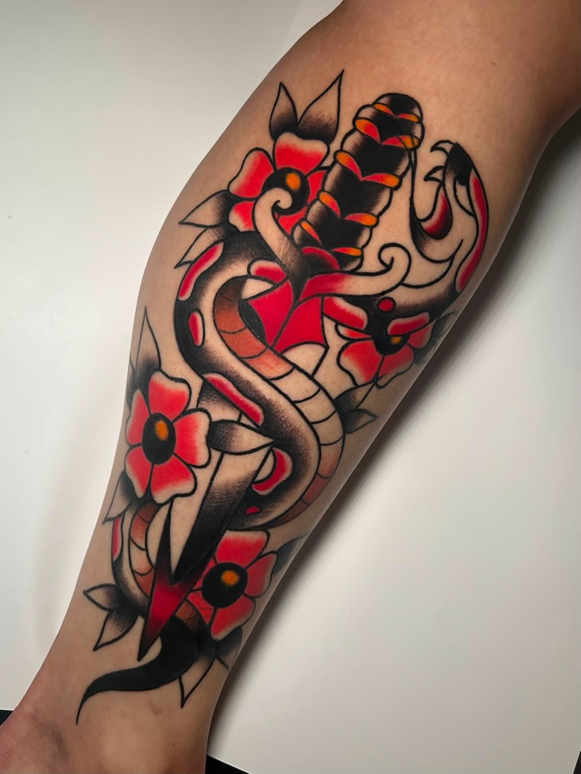 Dragon and flowers American traditional tattoo on the forearm by Cat ツ