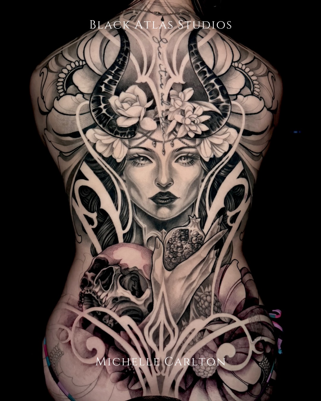 Woman with horns and flowers realism tattoo on the torso by Michelle Carlton