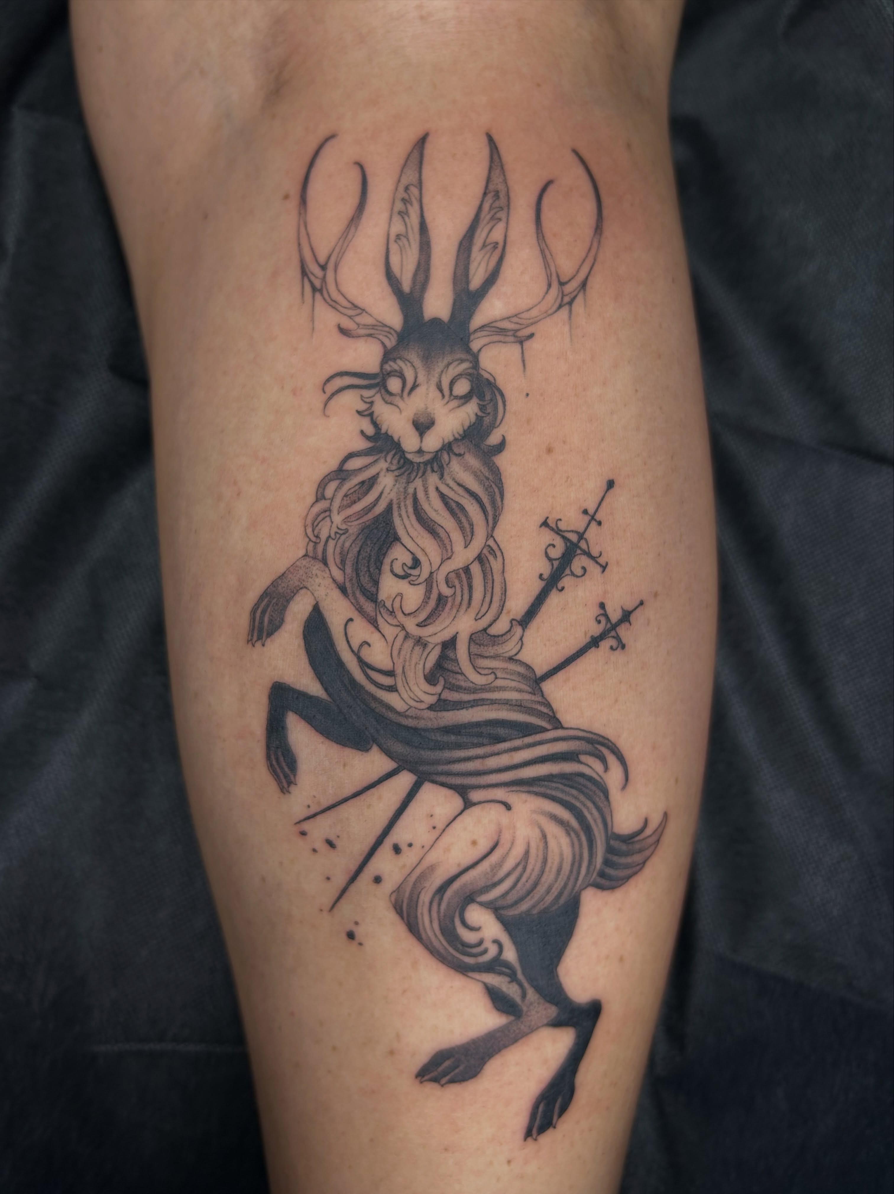 Rabbit with antlers black and grey tattoo on the forearm by Magnus