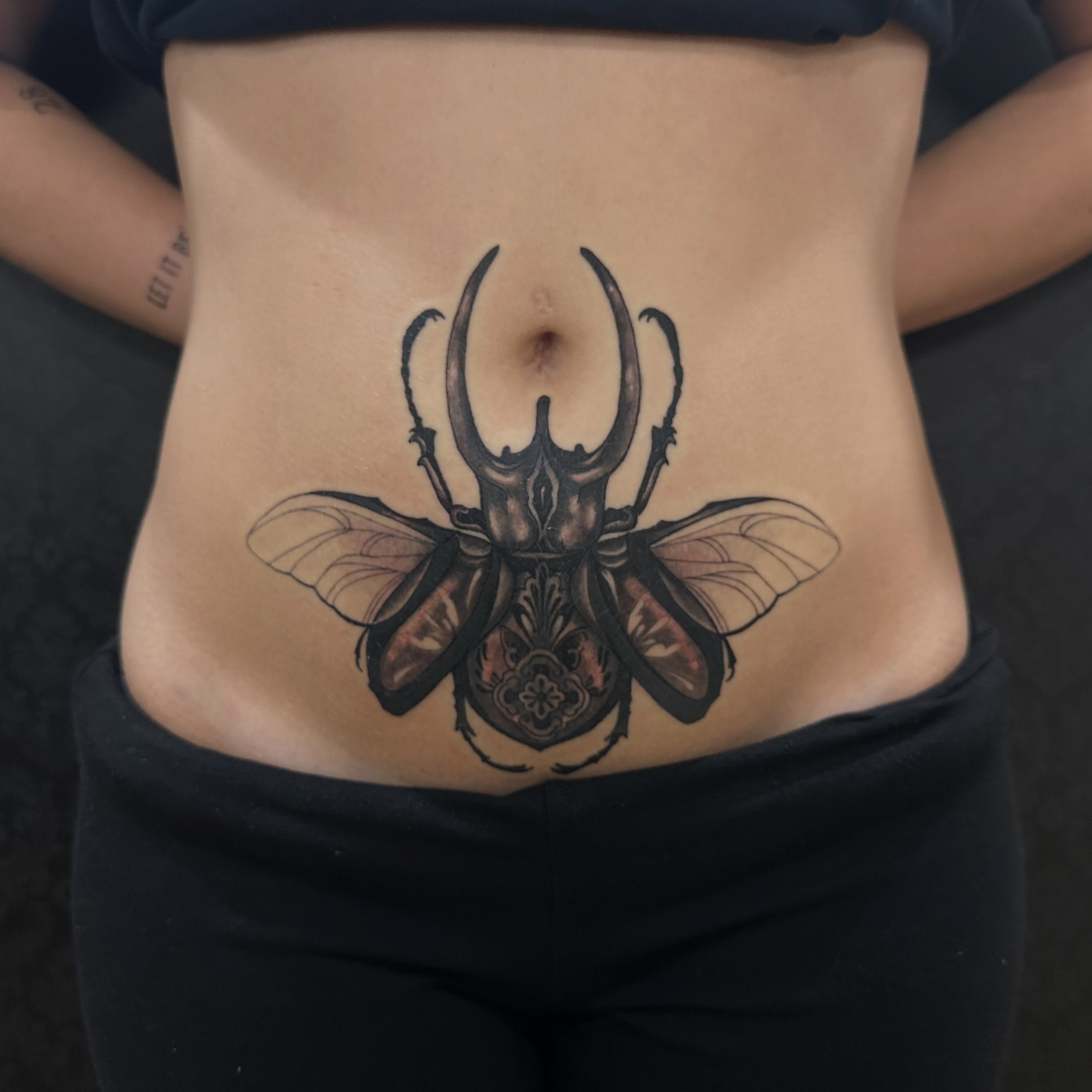 Rhinoceros beetle realism tattoo on the torso by Emma