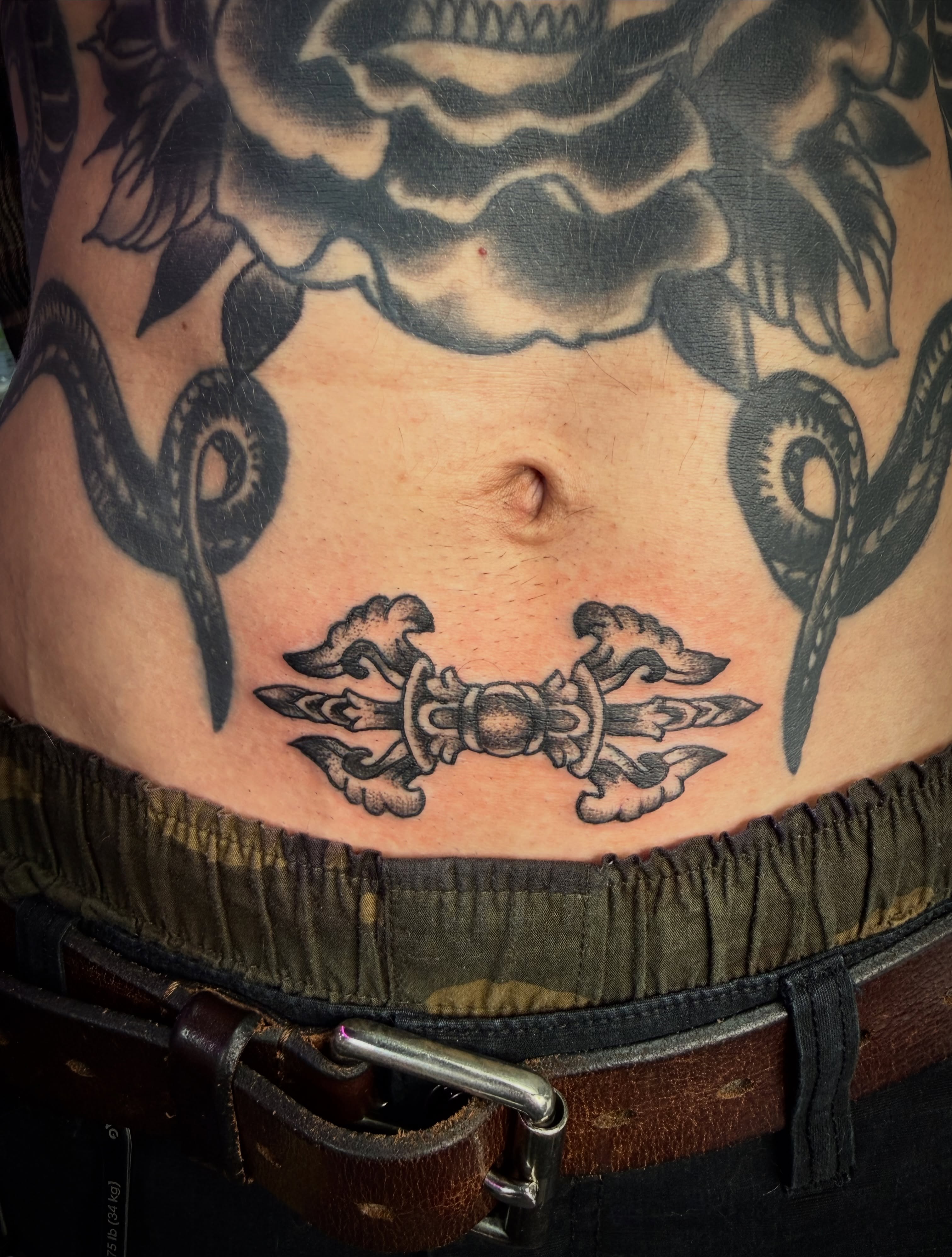 Crossed swords black and grey tattoo on the torso by Shane Bonham