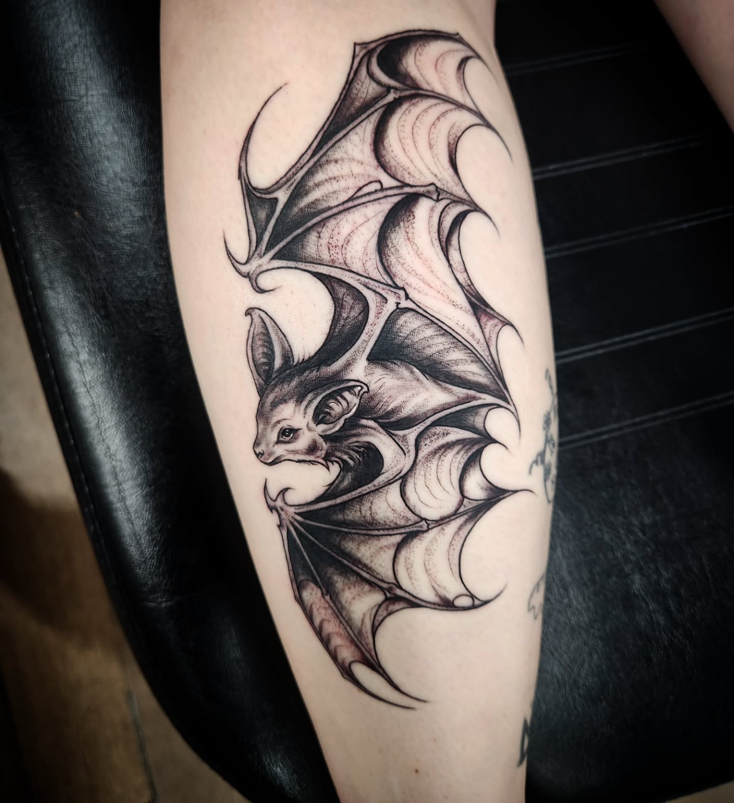 Bat black and grey tattoo on the forearm by Eric Richards